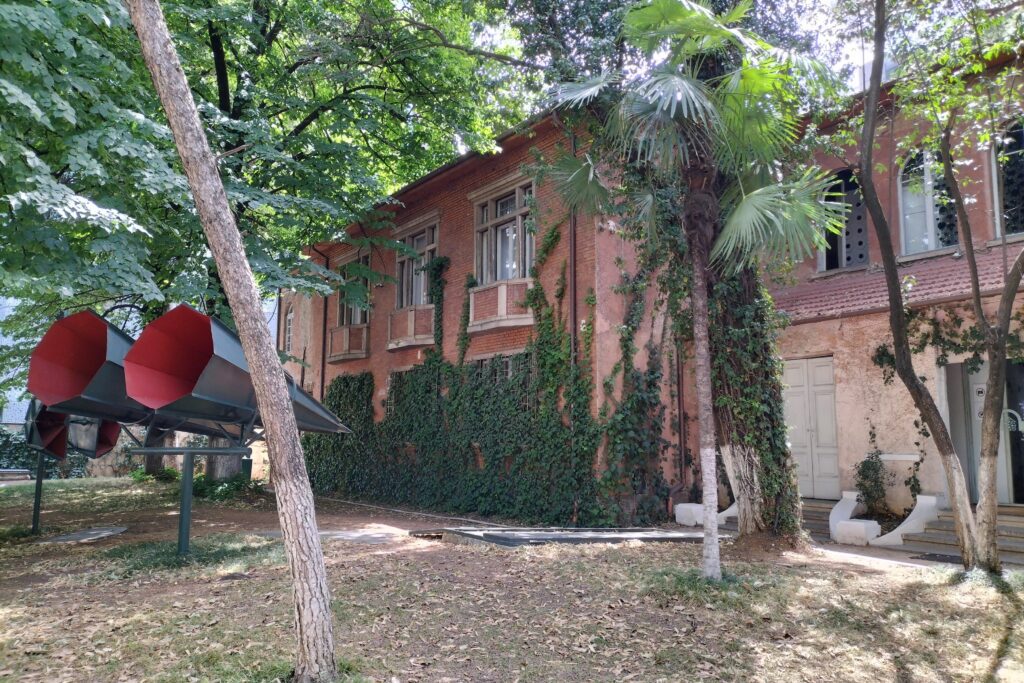 House of Leaves Museum has pink walls and is surrounded by trees