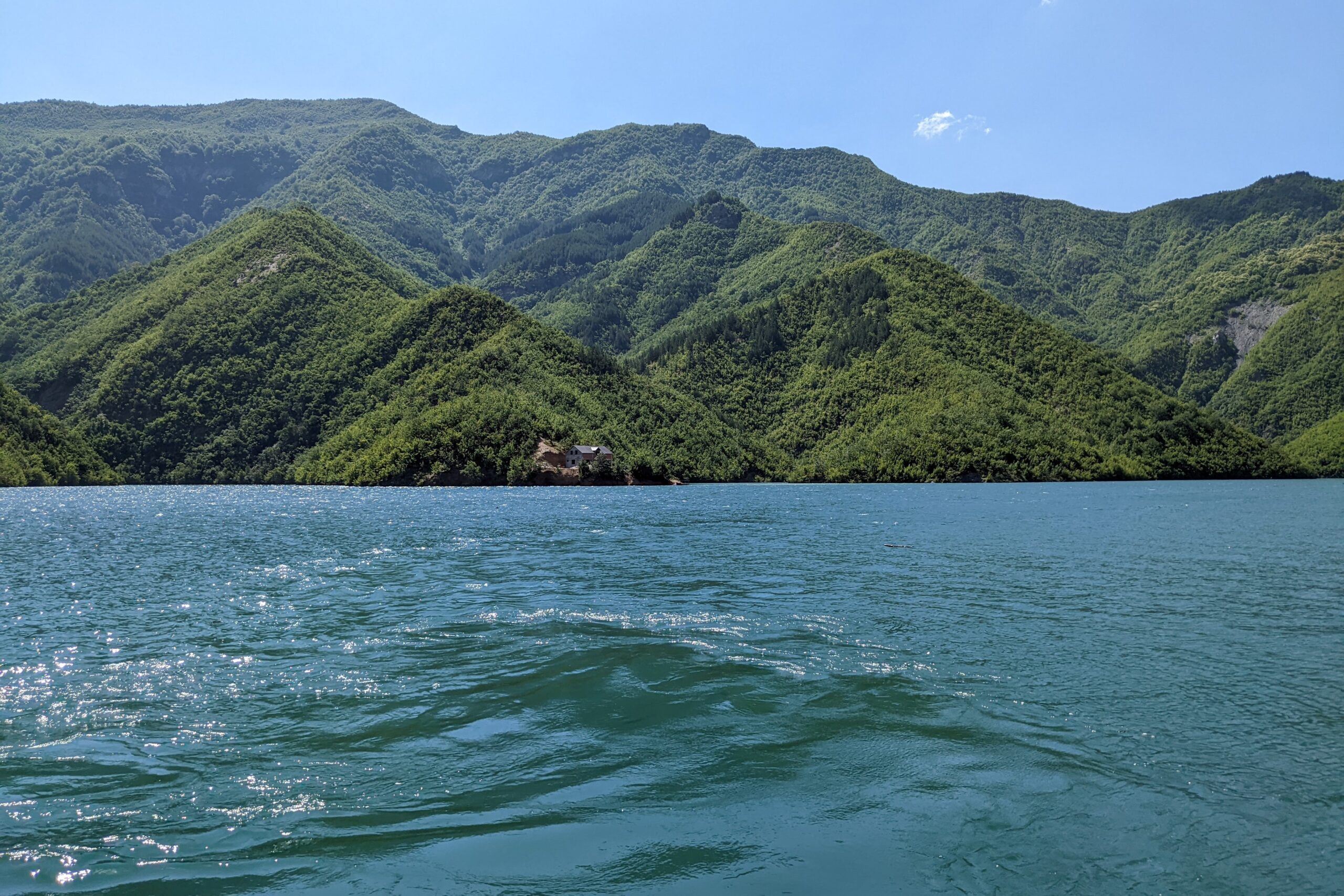 the water of Komani lake with mountains