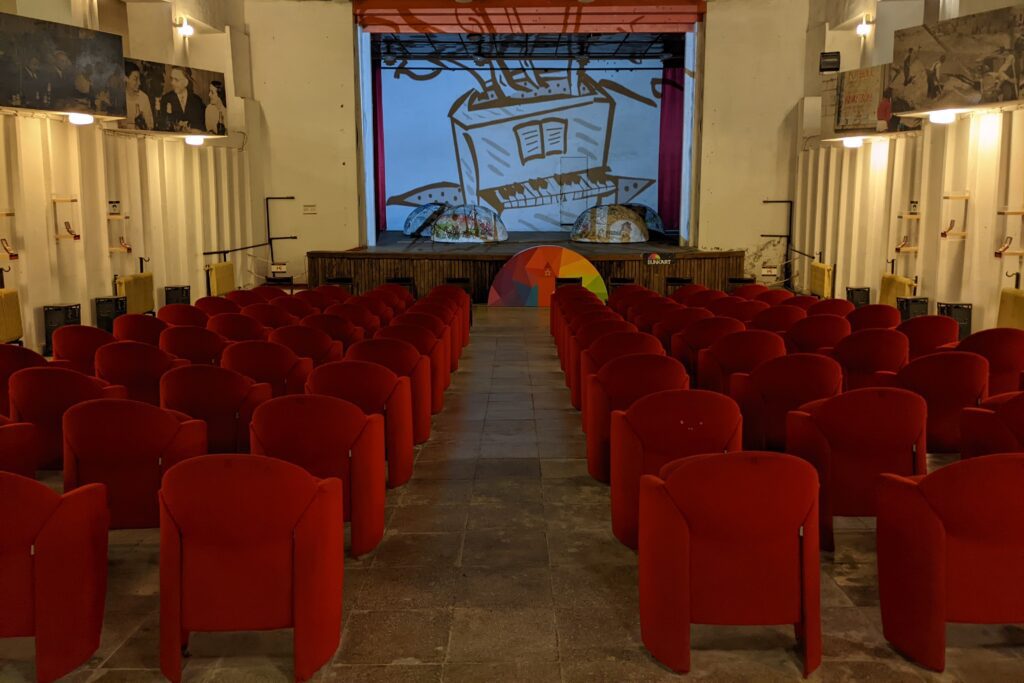 bunk art 1 assembly hall with red velvet chairs