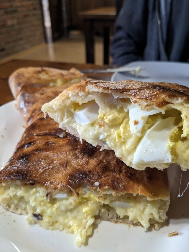 Guruli khachapuri Guruli khachapuri from Pirosmani - melted cheese and boiled eggs inside Georgian bread