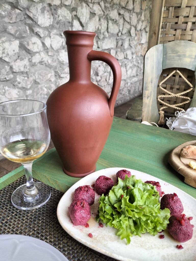 a jug of wine and beetroot pkhali 