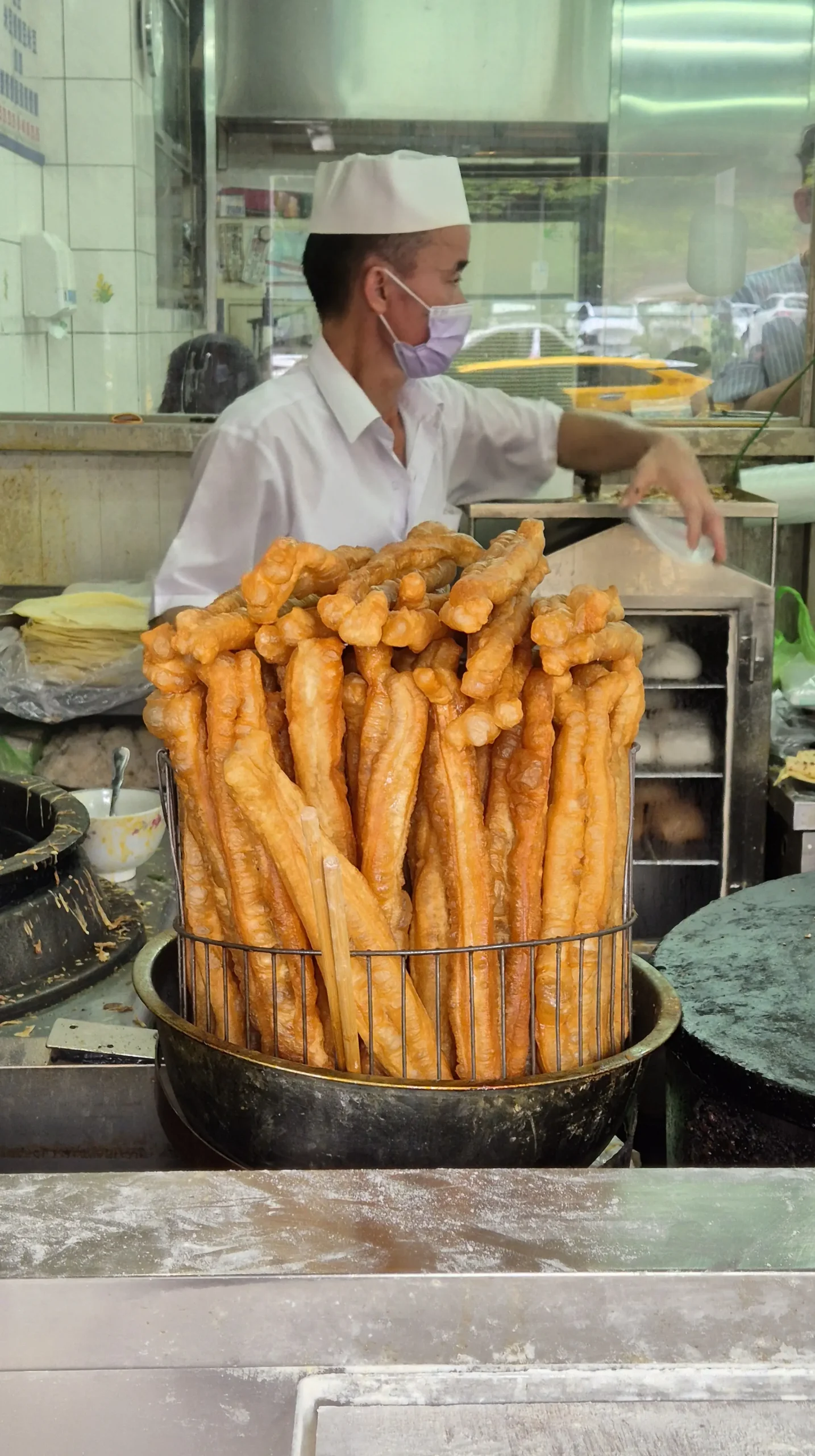 a huge pot full of Chinese doughnuts 