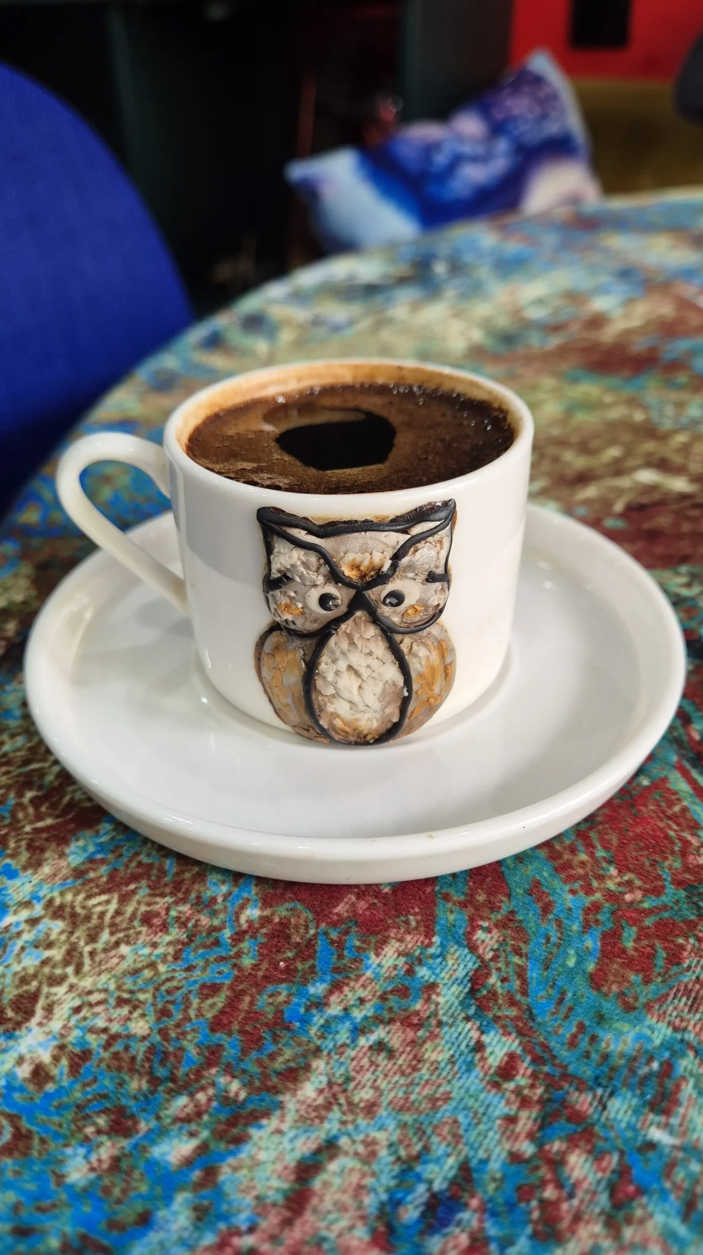 Bukioti Cafe, Kutaisi a small coffee cup with a an owl on it sits on a white saucer