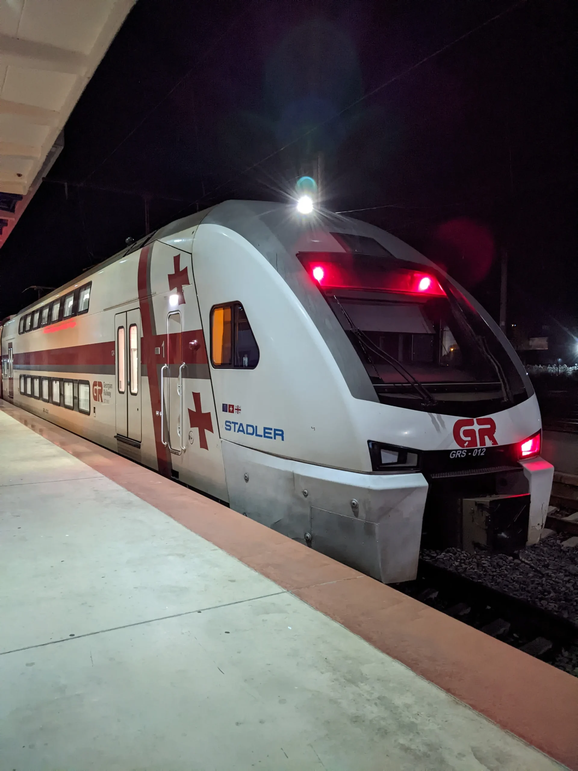 a modern Georgian train with Georgian flag decoration