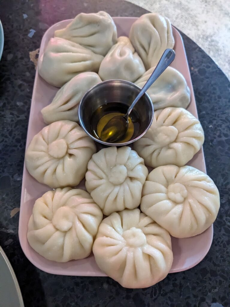 Veggie Khinkali, Tbilisi a plate of khinkali (Georgian soupy dumplings) and a small metal bowl of melted butter