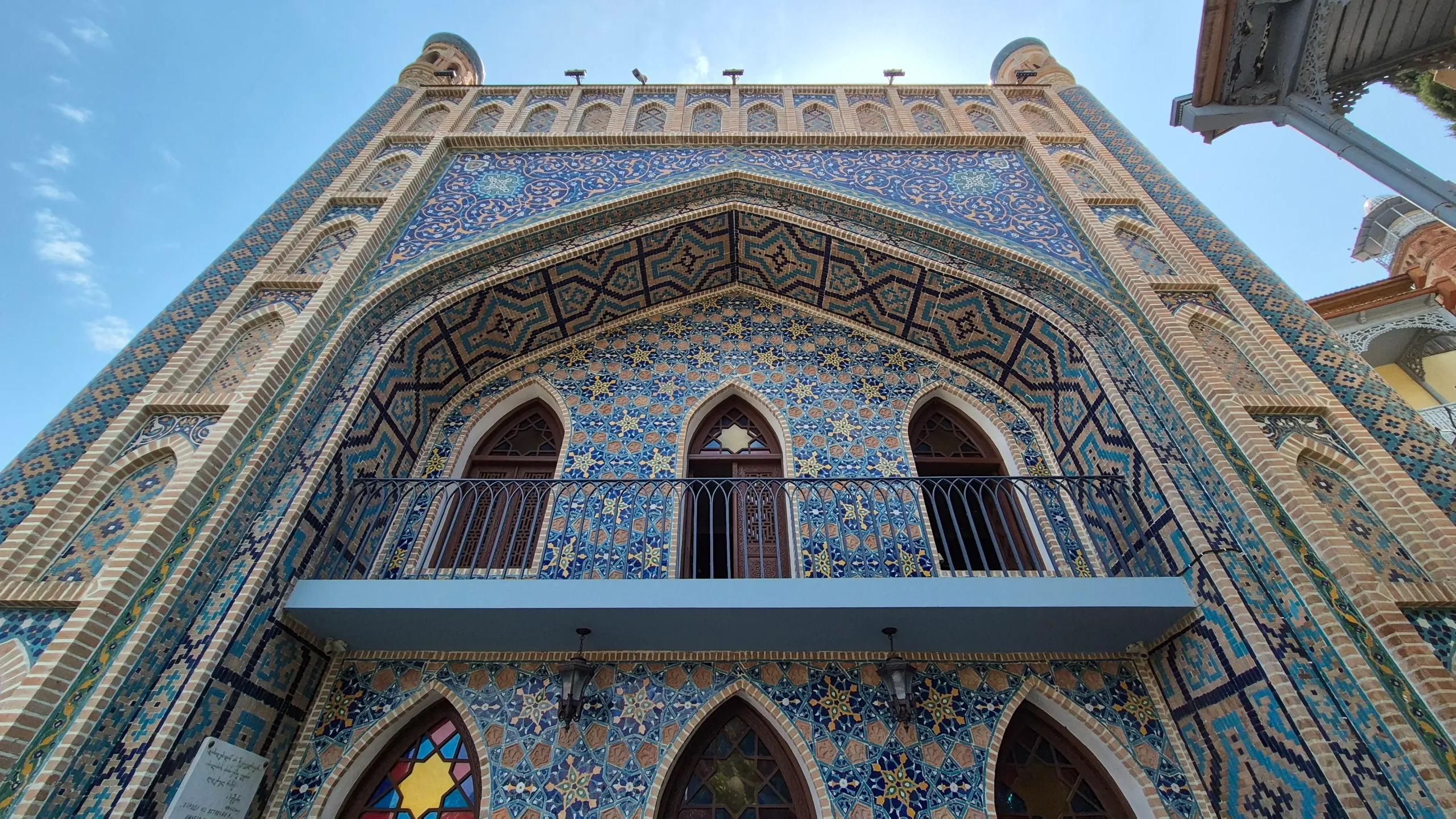 Chreli Abano a close-up of the decorative facade of Chreli Abano sulphur bath in Tbilisi has intricate blue tiling, a balcony, and arched doorways which look similar to that of the ancient Silk Road city buildings of Uzbekistan