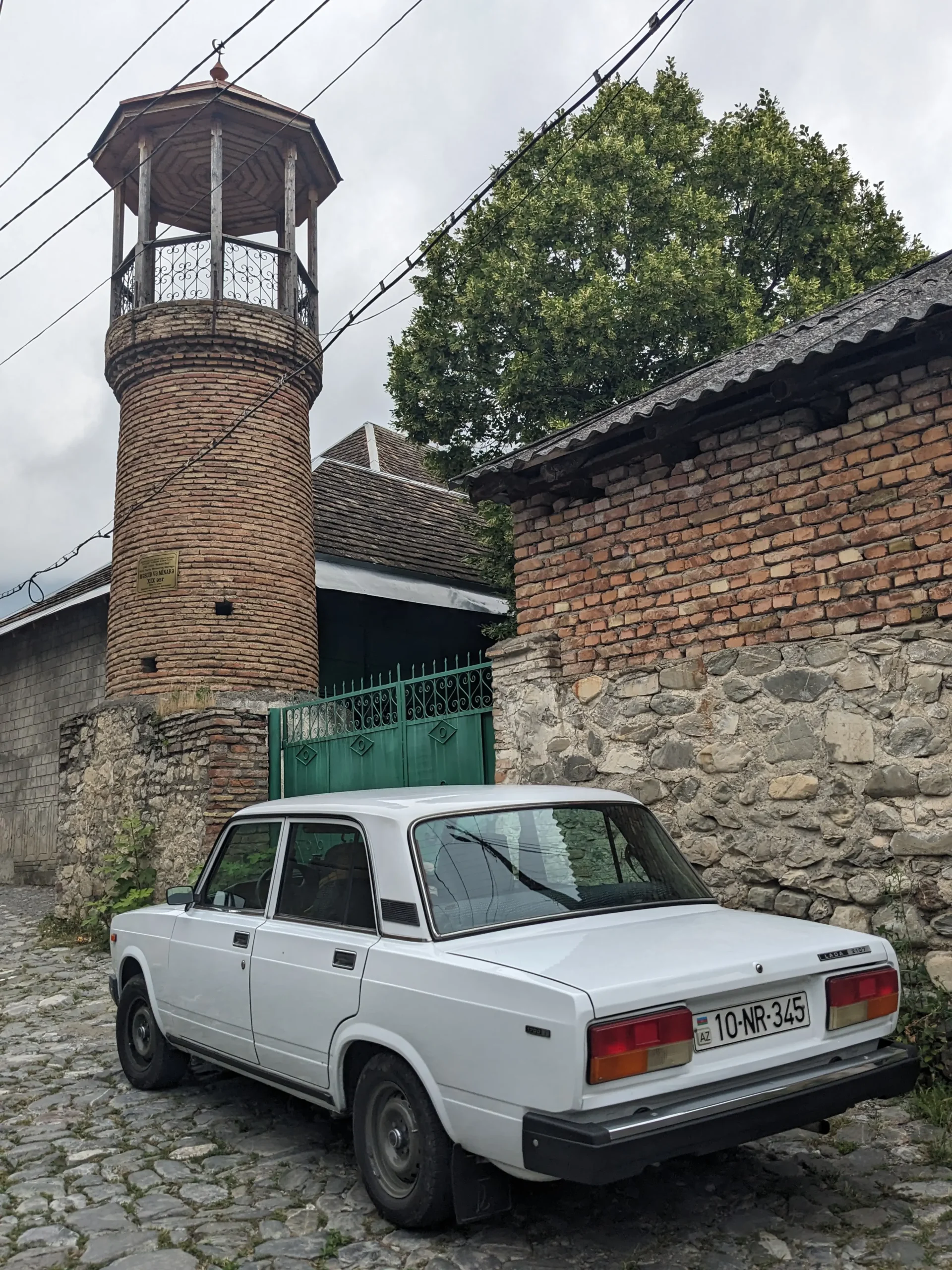 a Soviet Lada, cobbled streets, and a minaret in Azerbaijan