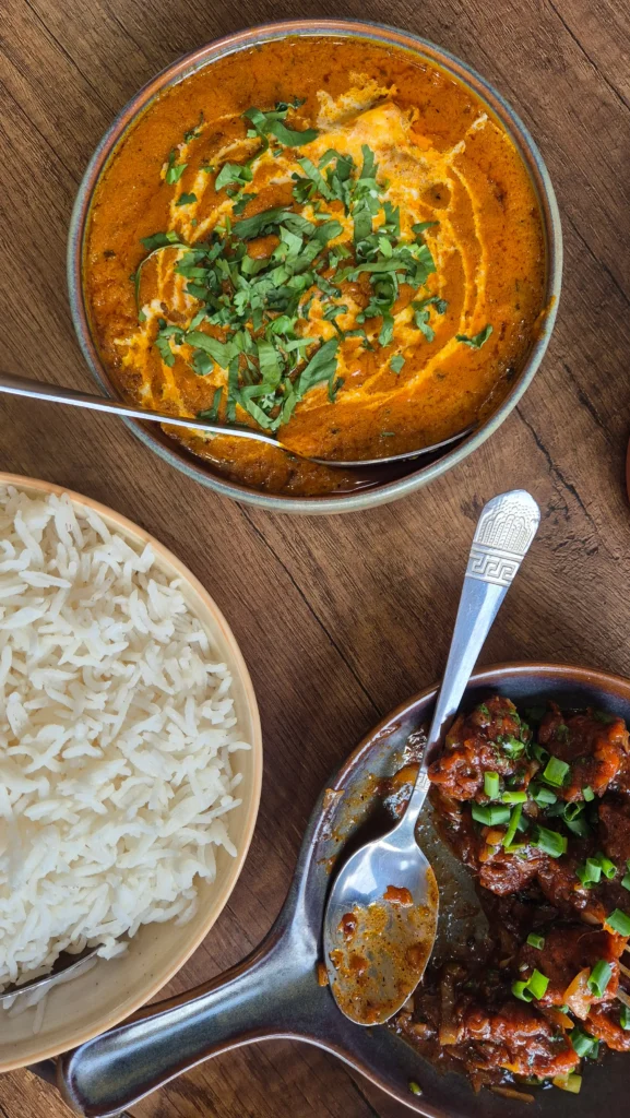the white elephant Indian restaurant three bowls of Indian food - rice, vegetarian manchurian, and paneer butter masala - from the White Elephant in Kutaisi, Georgia