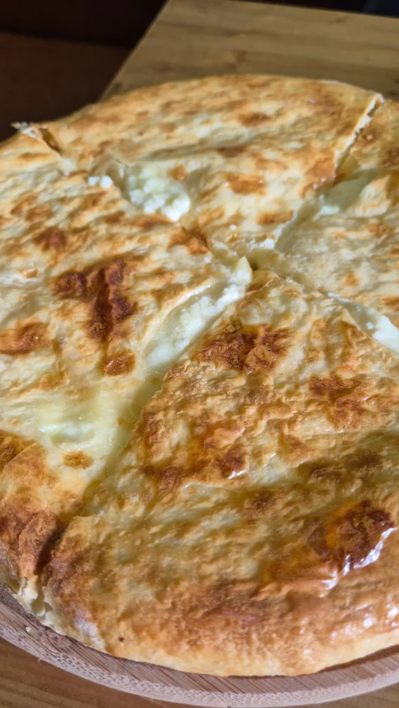 Imeretian khachapuri a close up of Imeruli khachapuri (Georgian bread with melted cheese inside)