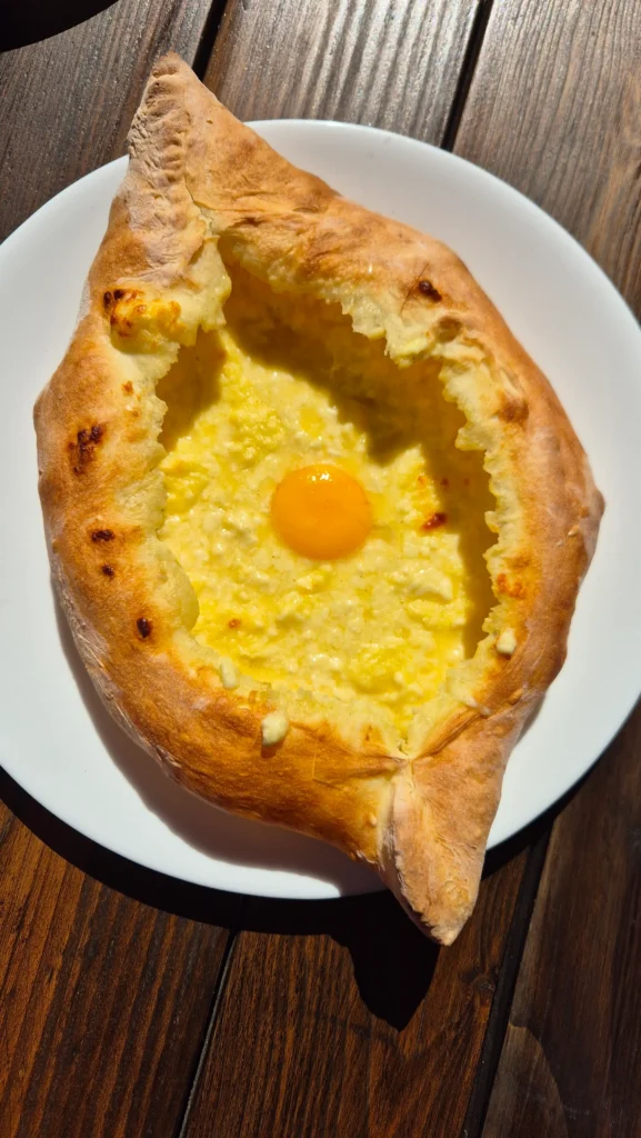 adjaruli khachapuri Adjaruli khachapuri is a bread boat filled with melted cheese and a runny yolk