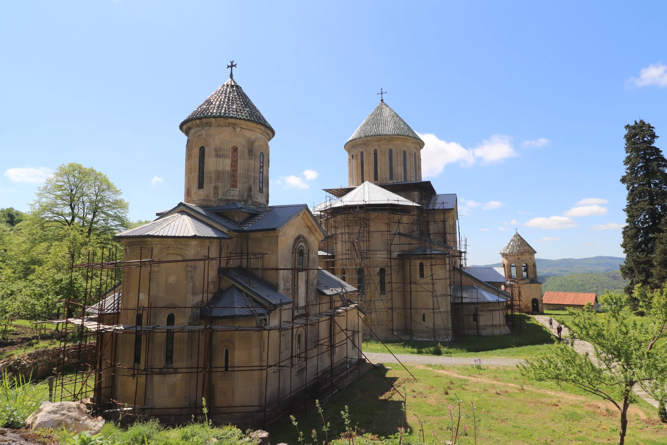 an external view of UNESCO listed Gelati Monastery with trees and blue skies