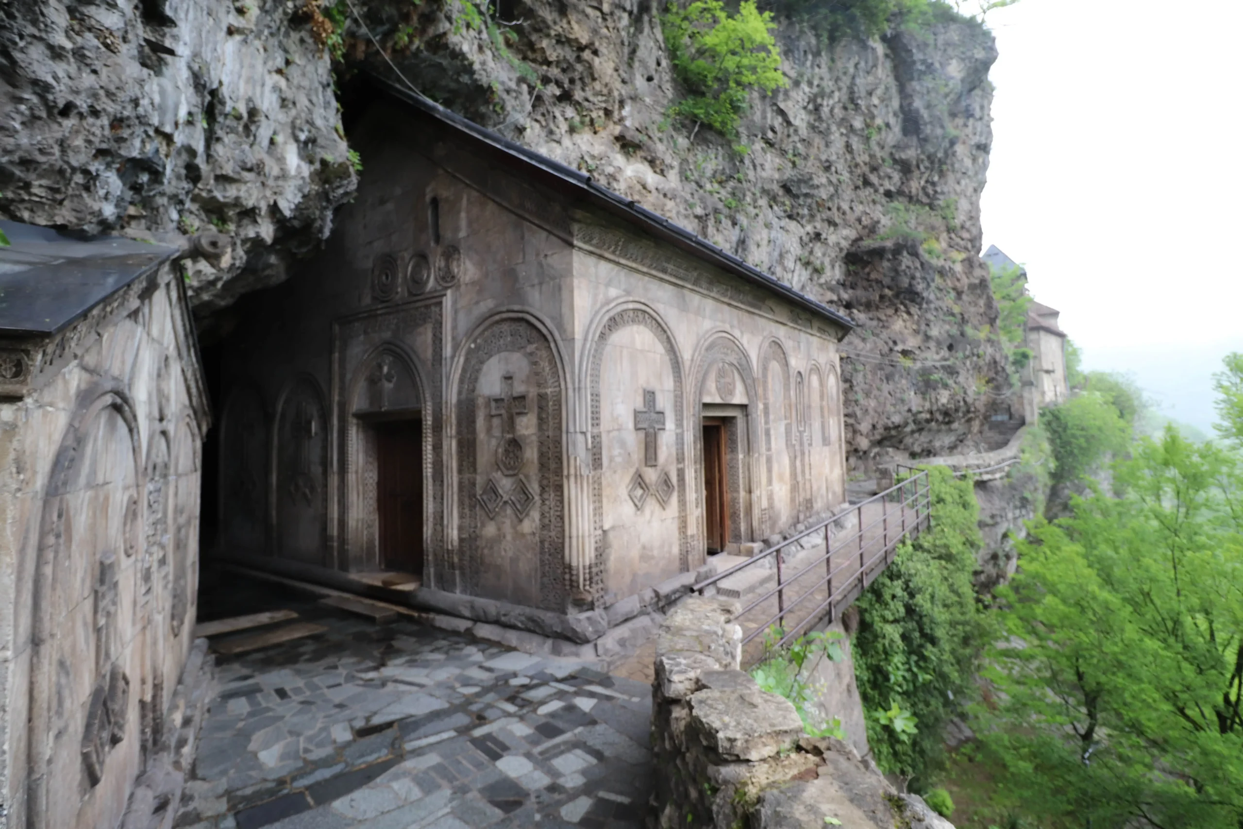 Mgvimevi Convent has a historic church built into the cliff face - things to do in chiatura