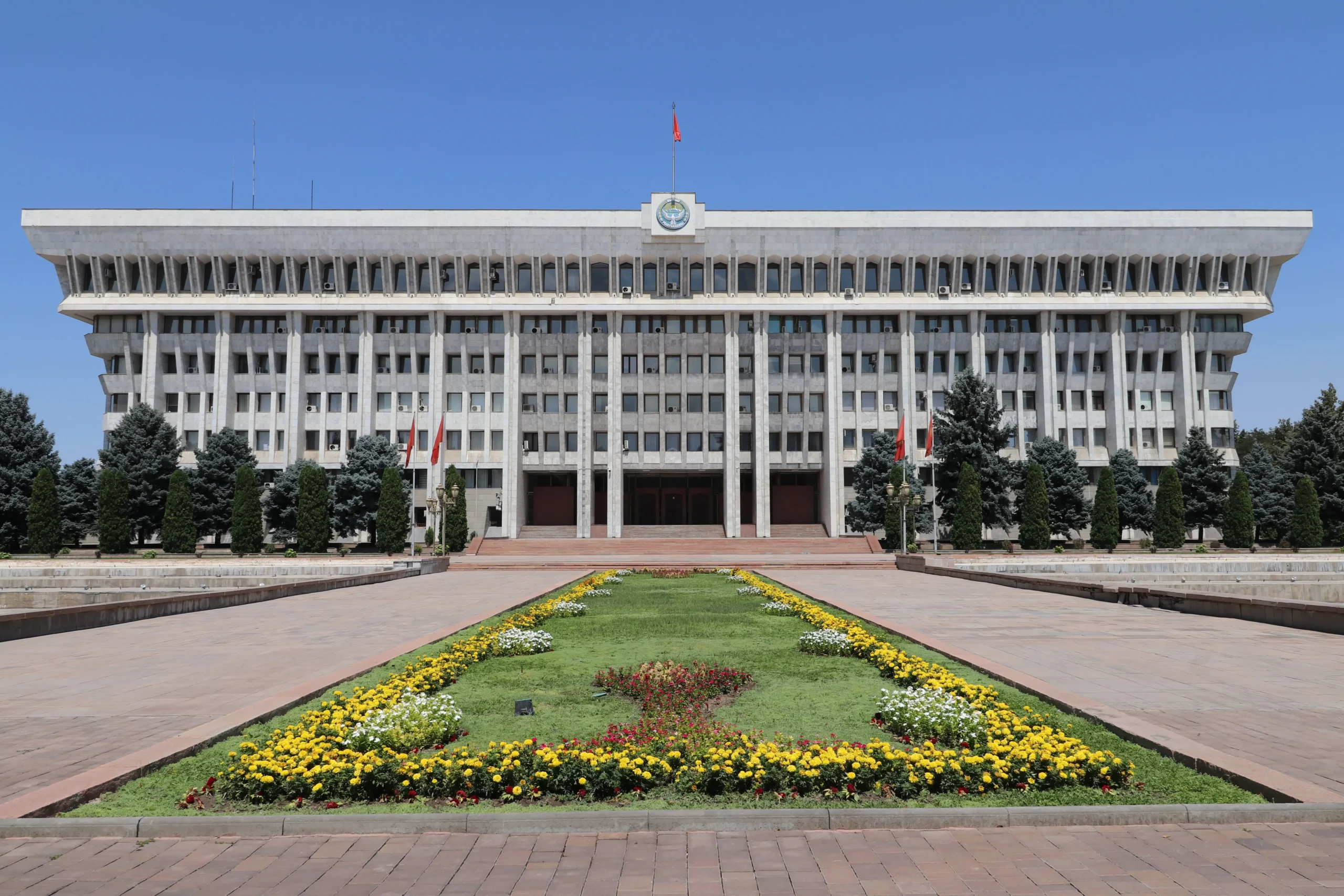 White House, Bishkek Bishkek's parliament building is huge, white, symmetrical, has harsh concrete straight lines and a Kyrgyz flag flying on top.