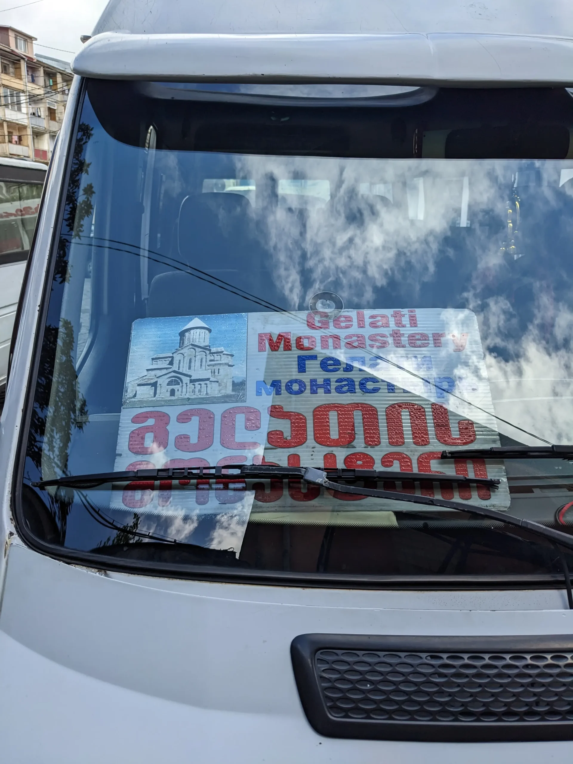the window of a marshrutka with a sign for Gelati Monastery, Kutaisi.