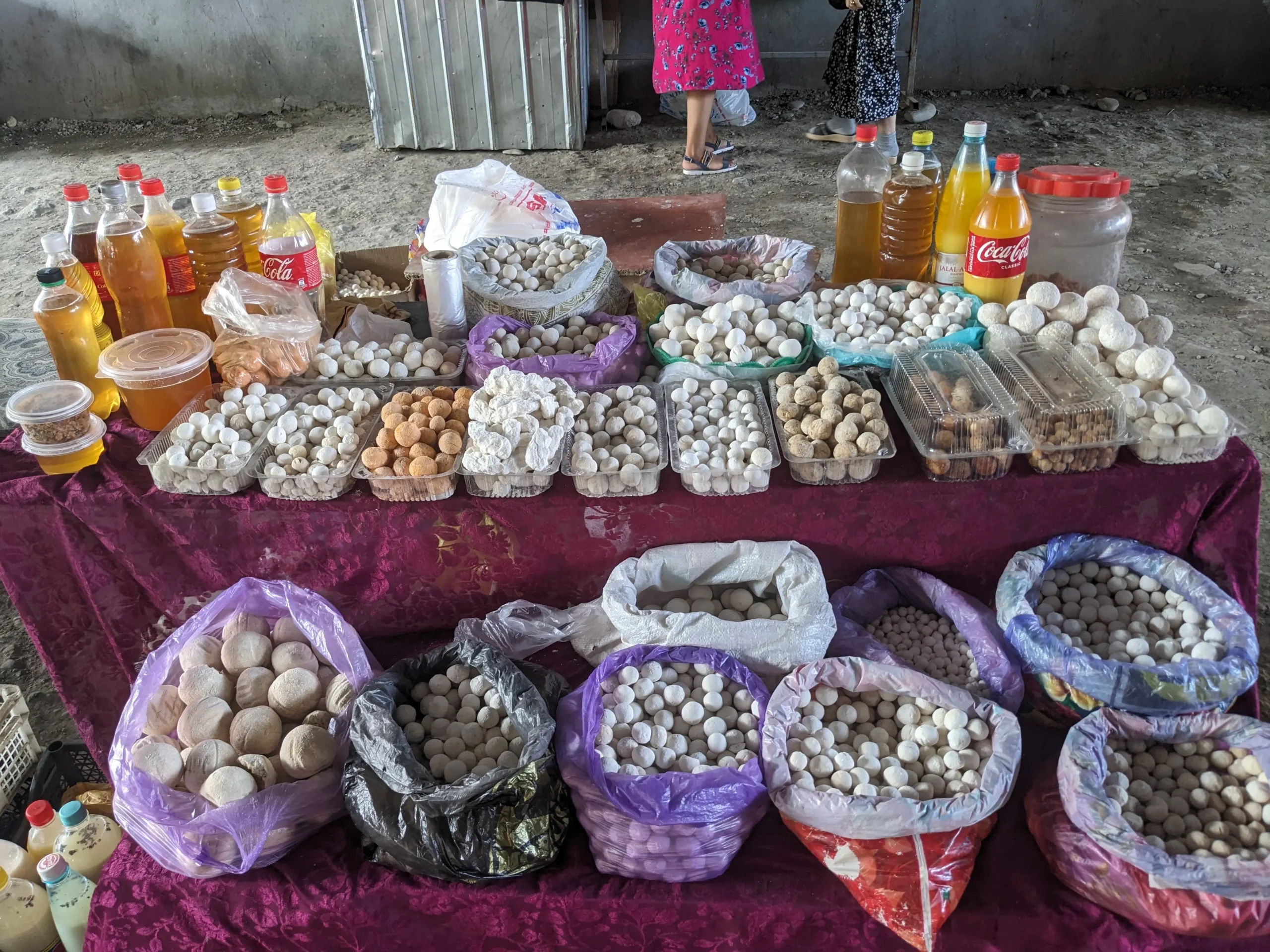 Qurut stand at Osh market a market stall has at least twenty different bags/containers of different varieties of qurut - Kyrgyz fermented and dried yoghurt balls