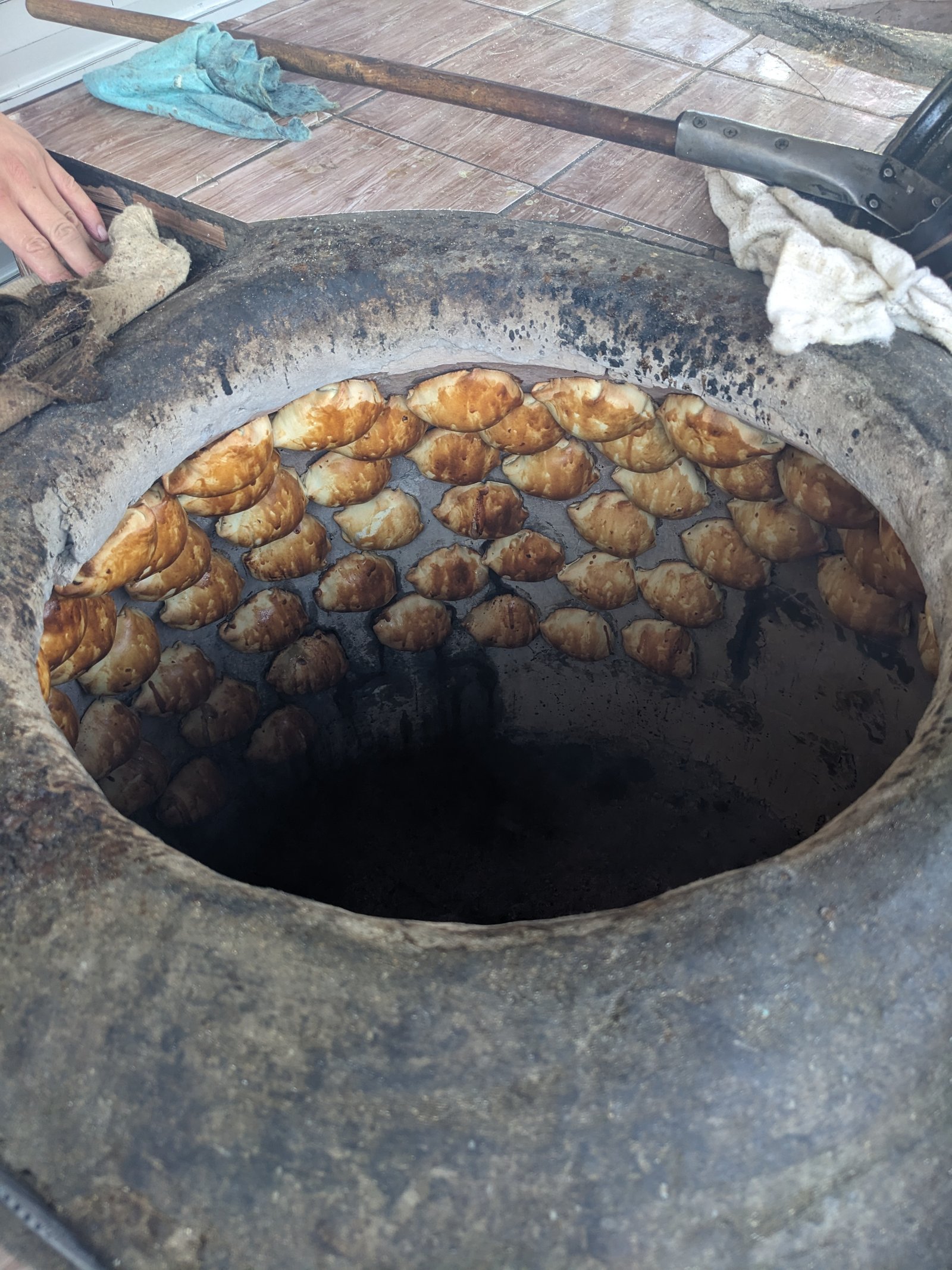 Samsa a traditional Kyrgyz tandyr has samsa cooking up against the inside