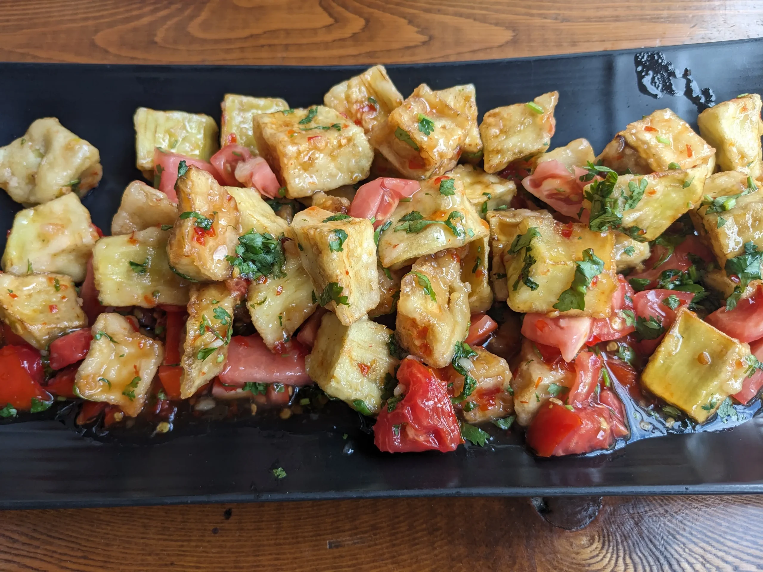 Salat Shirin cubes of lightly battered and deep-fried aubergine with tomatoes and herbs covered in a sweet chilli sauce - Karakol, Krygyzstan