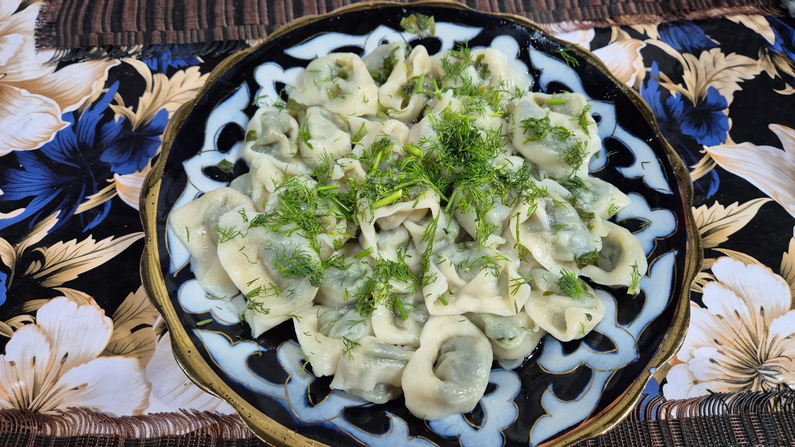 pelmeni from Sitora Kafe a plaet of pelmeni (greens and herb stuffed dumplings) topped with fresh dill in Sitora Kafe, Bukhara, Uzbekistan