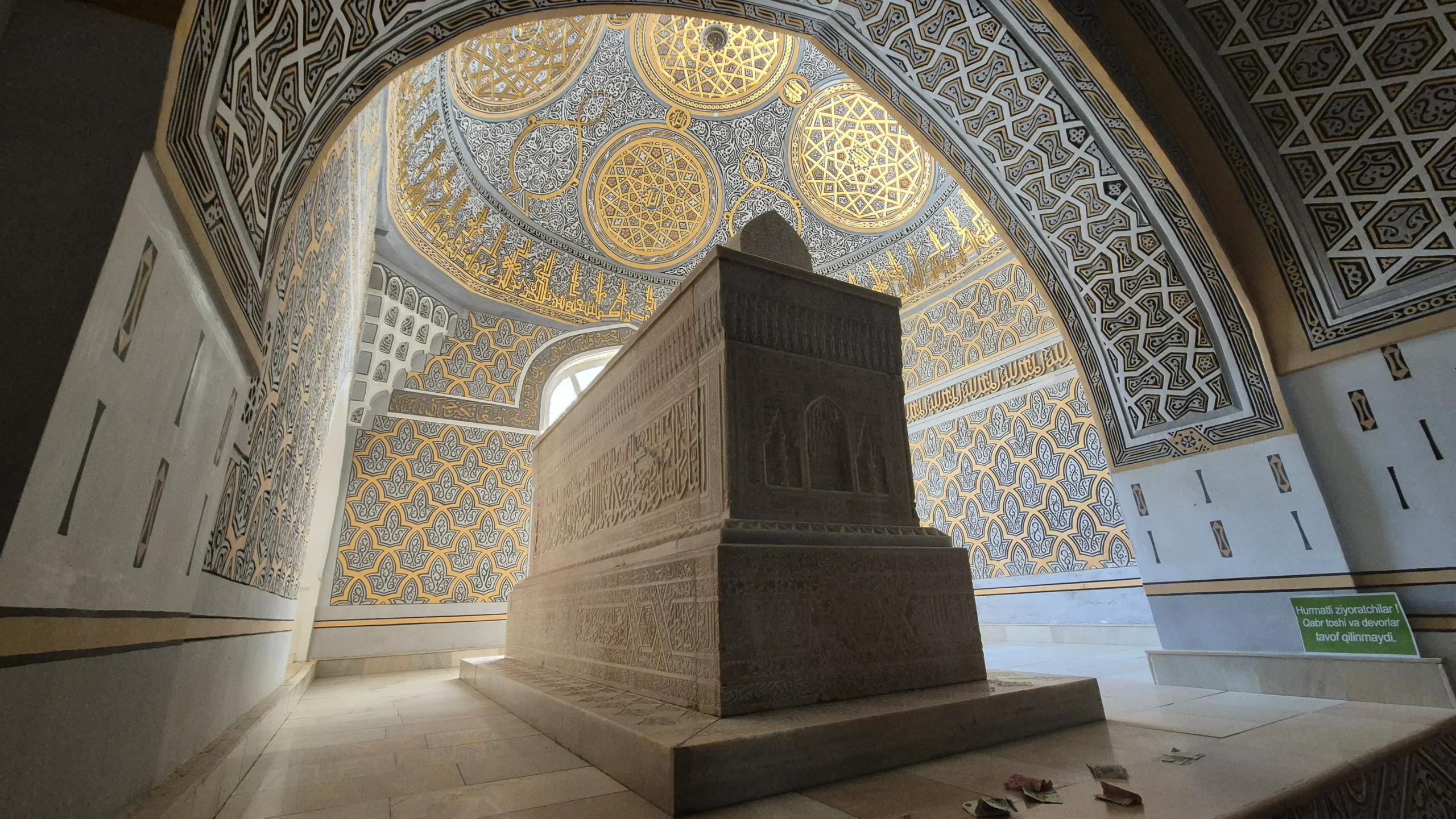 Al Hakim At-Termizi Mausoleum inside of Al Hakim At-Termizi Mausoleum has blue, white and gold tiling in geometric designs.