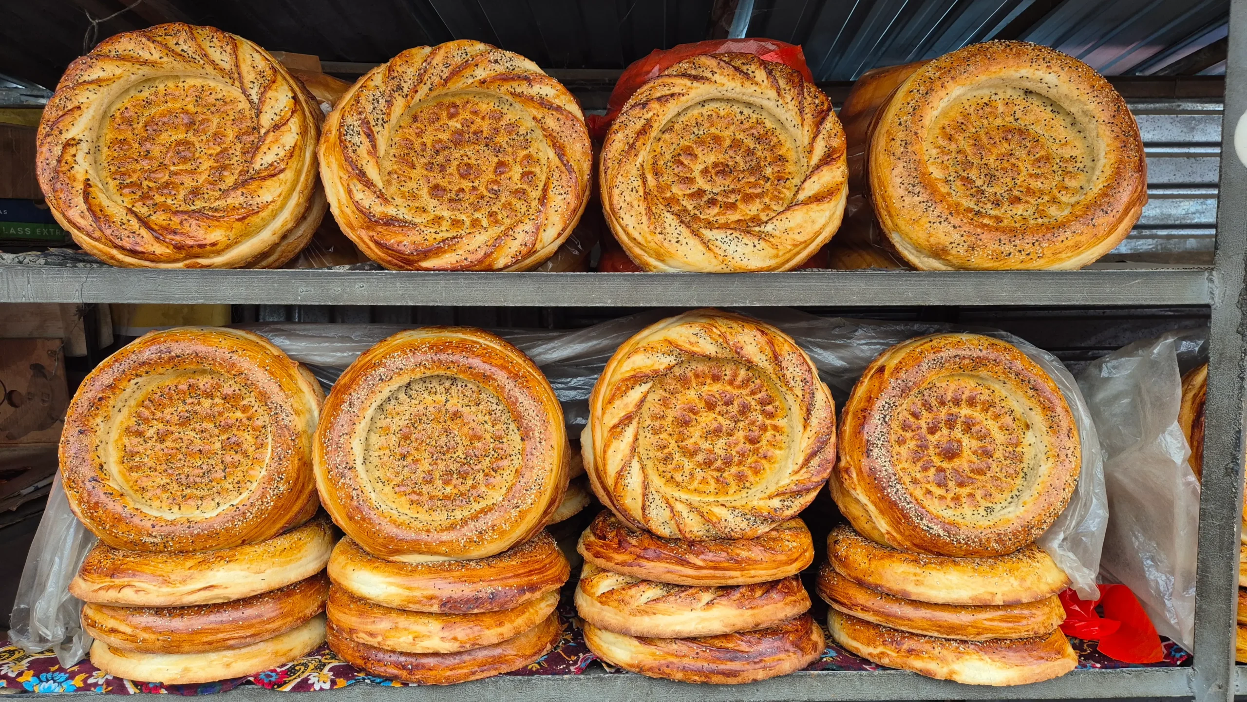 stacks of circular Kyrgyz bread at Osh Bazaar has a flower imprint in the centre.