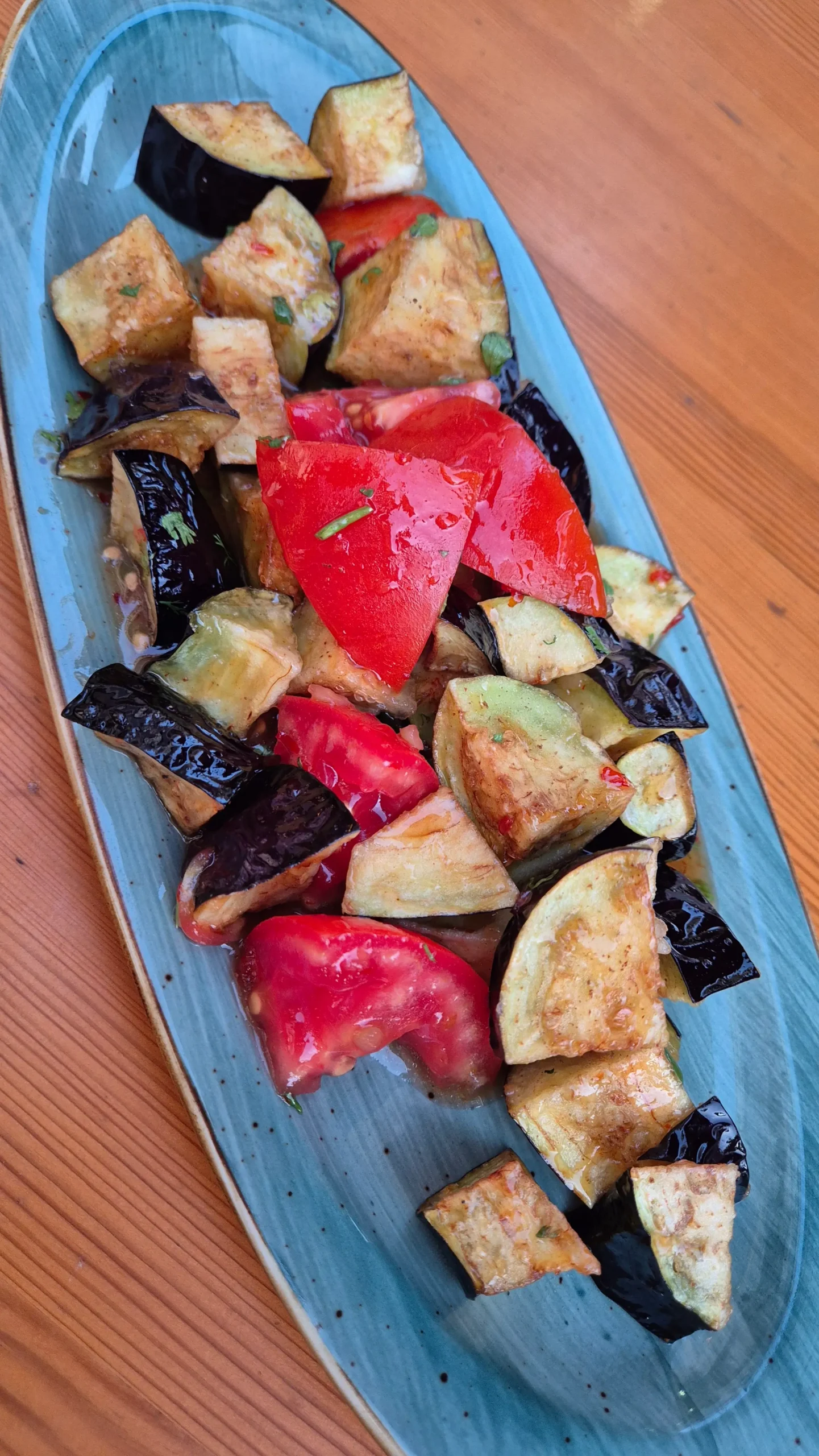 a plate of Kyrgyz salat shirin (fried aubergine mixed with fresh cucumber and a sweet chilli dressing)