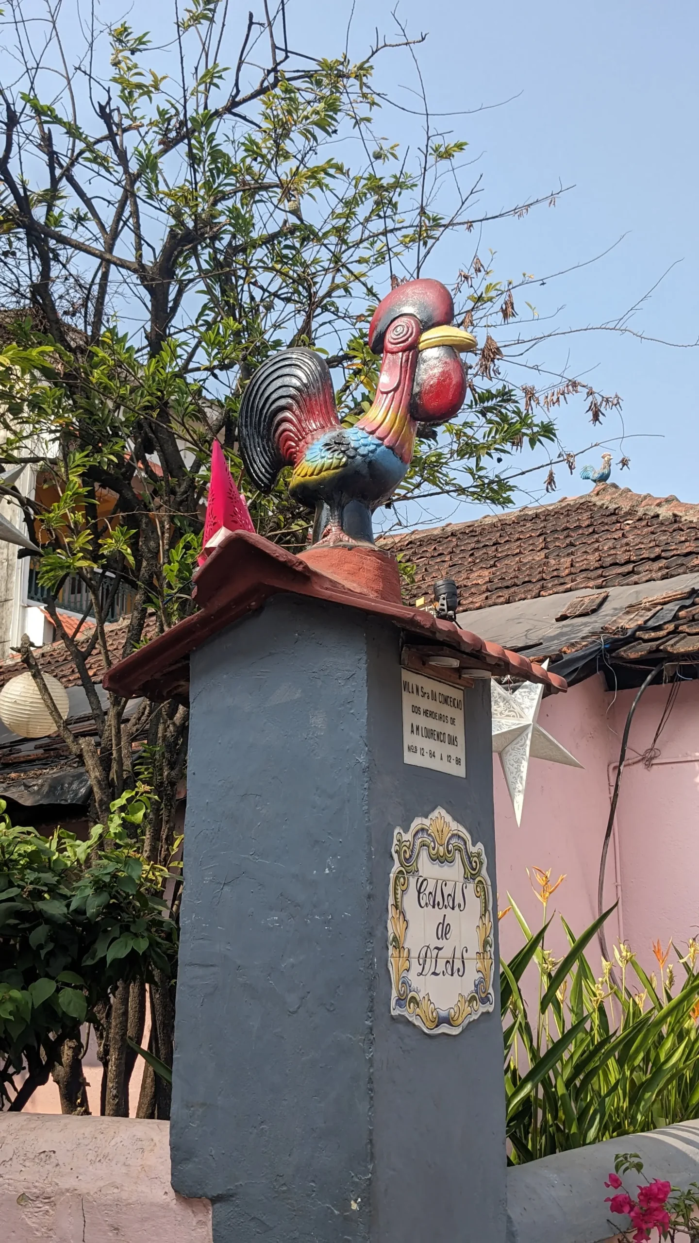 Portuguese cockerel a red, yellow and blue Portuguese cockerel statue stands atop a pillar in Panaji, Goa, India