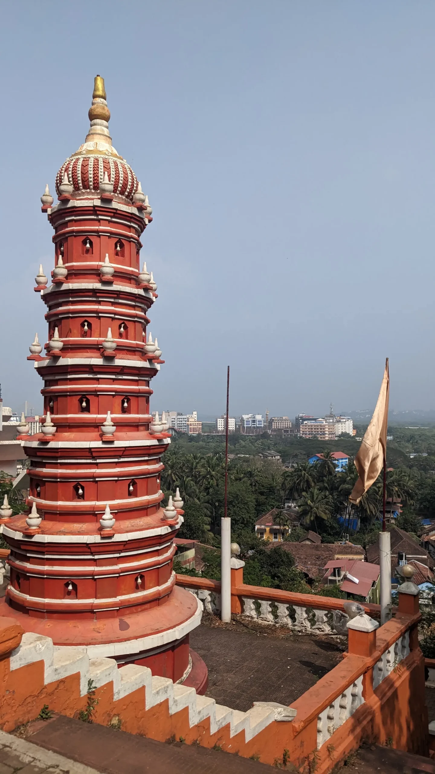 Orange Tower of Maruti Temple a tiered tower is decorated in bright orange and white overlooking the city of Panaji, Goa, India. Maruti Temple