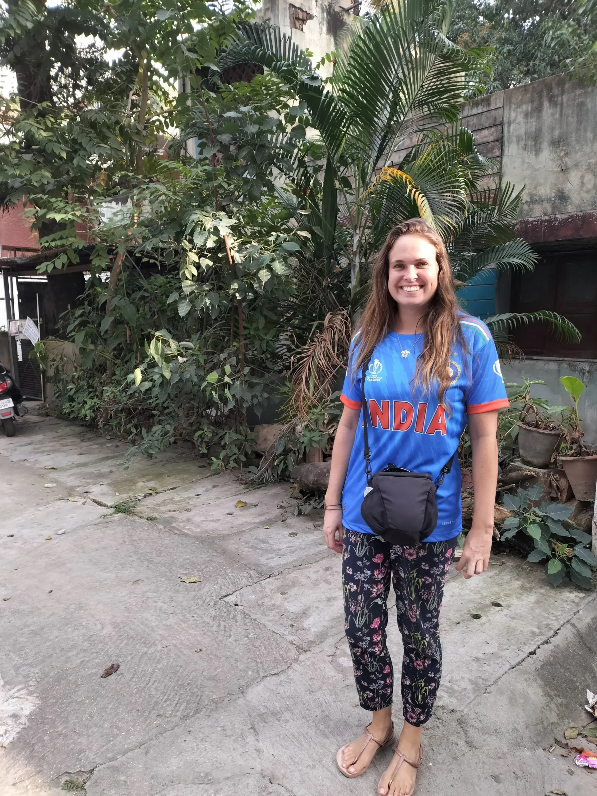 a woman wears a blue and orange  Indian cricket shirt in Bangalore