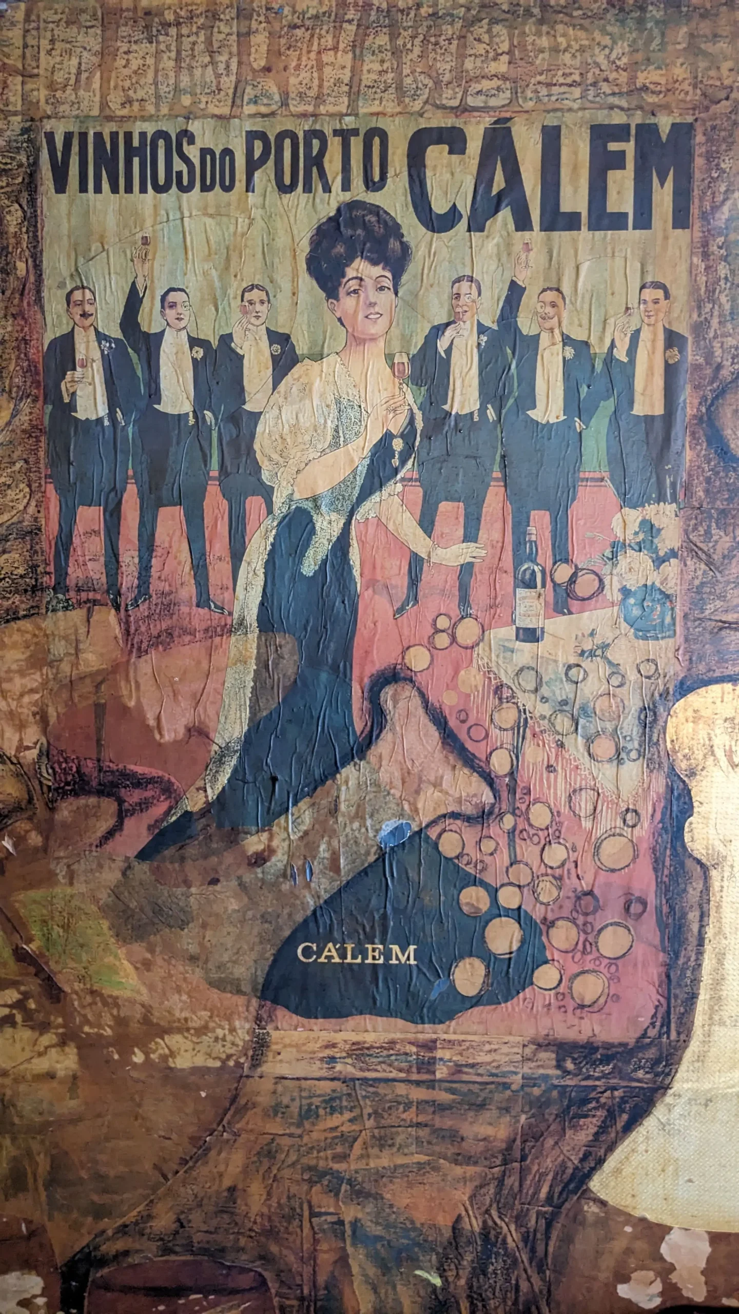 Old Portuguese poster an old poster has writing in Portuguese and pictures a woman holding a glass of wine with six men in the background in Hospedaria de Venite, Panaji, Goa, India
