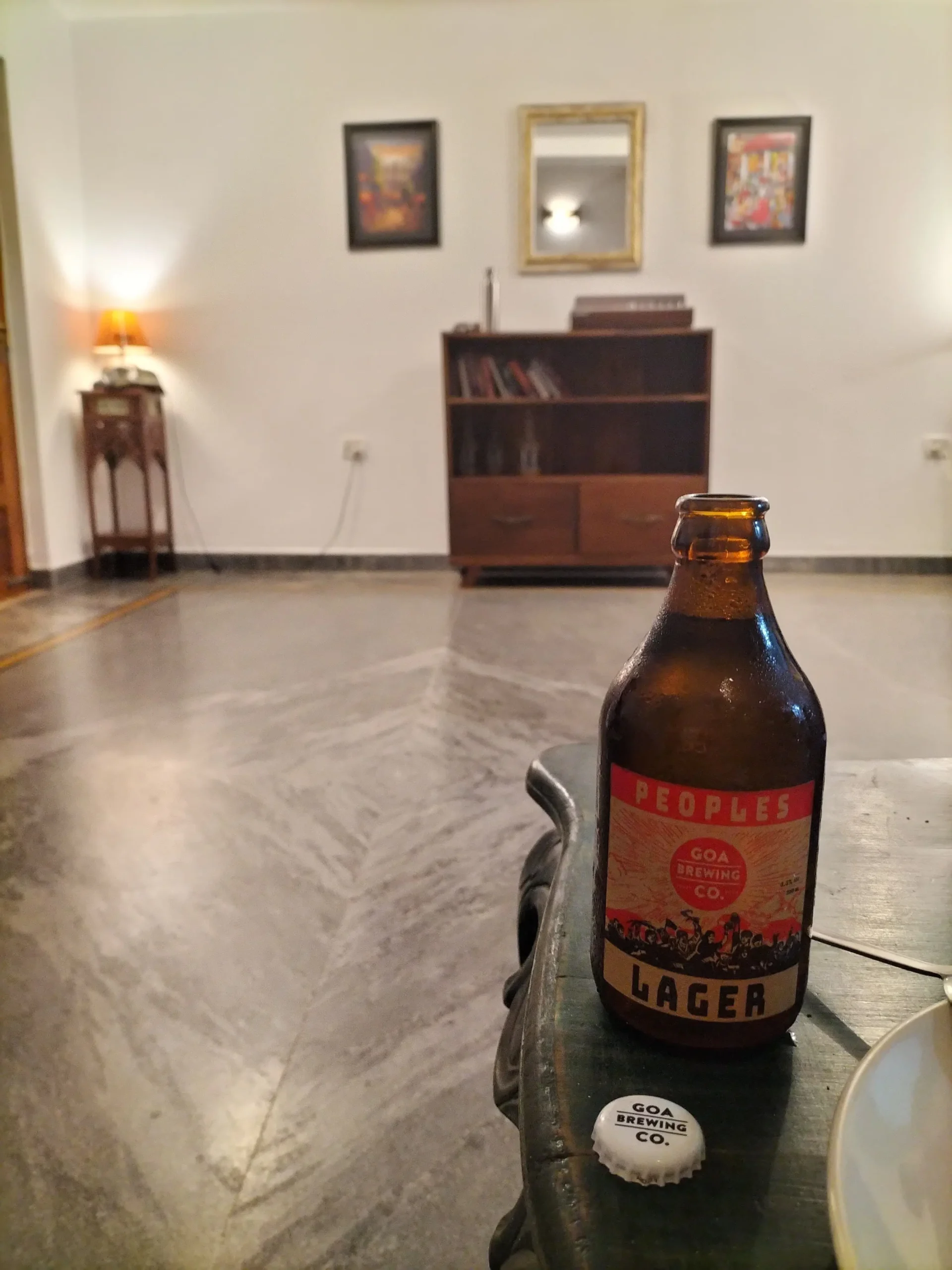 People's Lager a small brown glass bottle with a red, black and white label reads 'People's Lager: Goa Brewing Company'