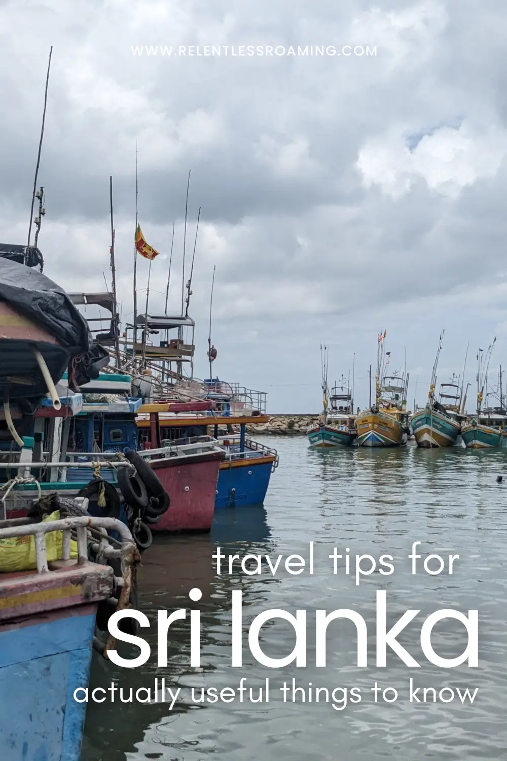 travel tips for sri lanka pin colourful boats are docked at the sea harbour in Tangalle, Sri Lanka