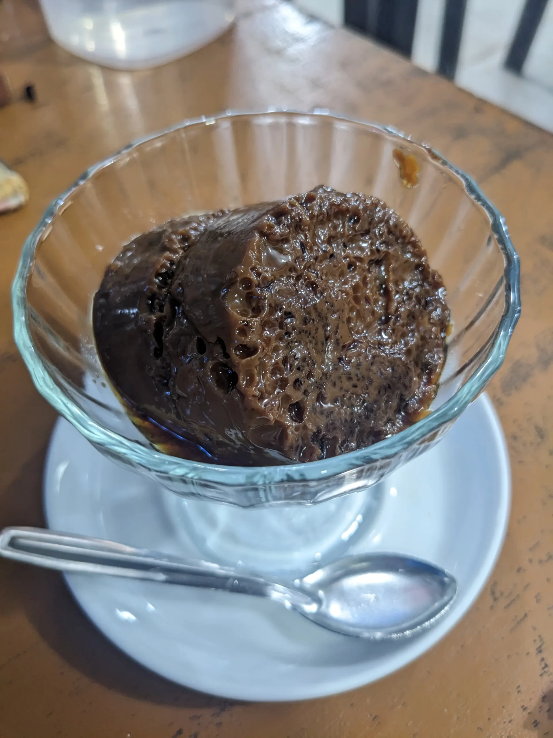 a glass bowl of a dark brown set custard pudding - Sri Lankan wattalapan