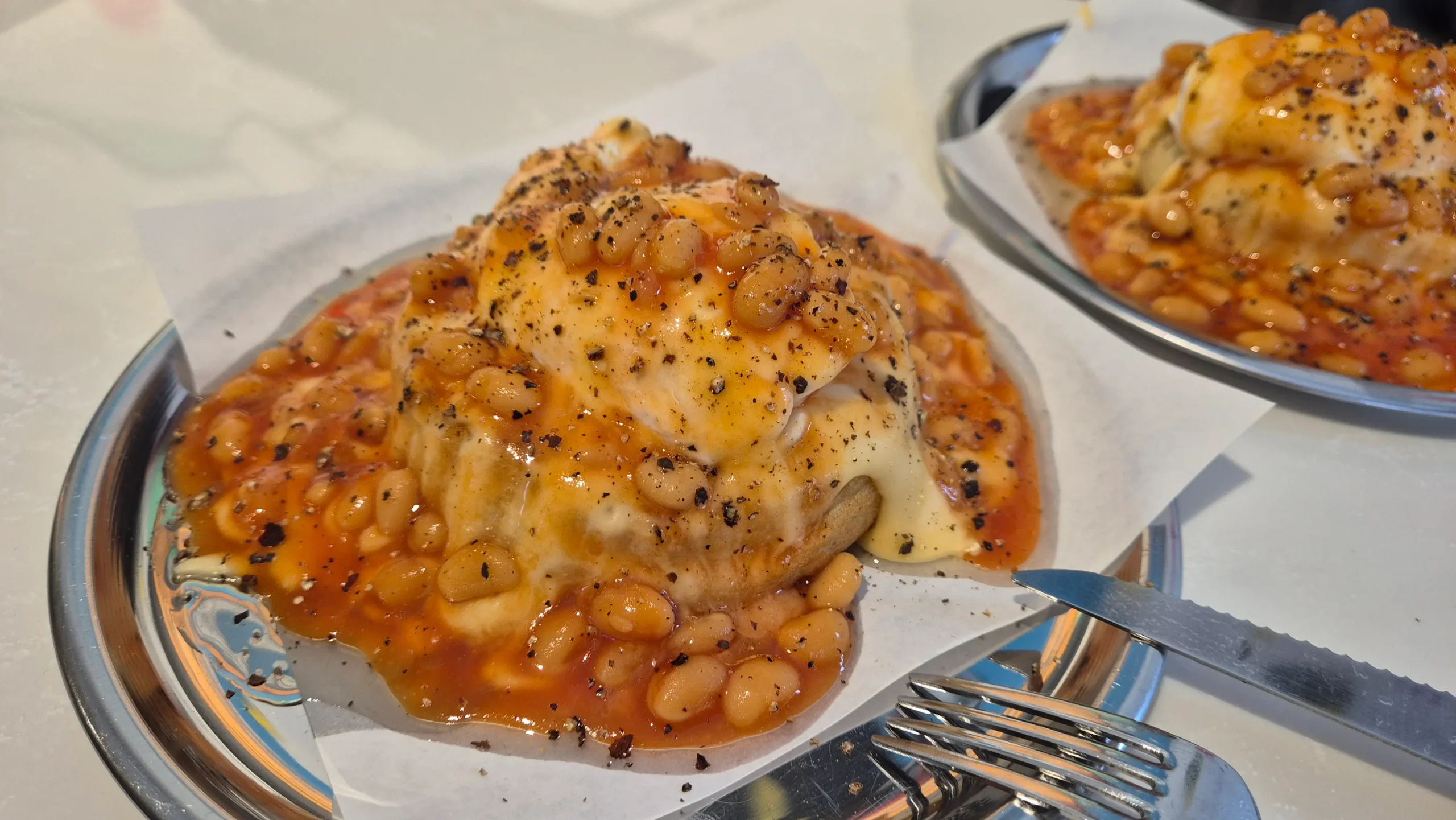 crumpets a crumpet topped with cheese, baked beans and a poached egg at Crumpet London, Istanbul