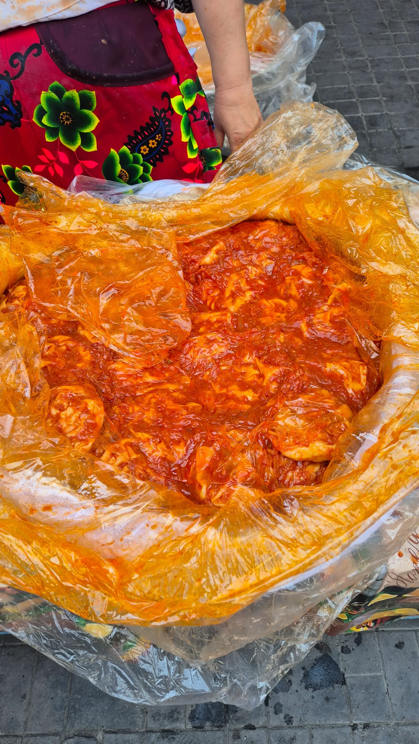 a large plastic bag full of khanum (large Uzbek ravioli) smothered in tomato sauce at Chorsu Bazaar, Tashkent