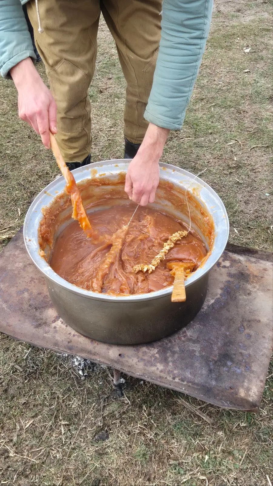 making churchkela at Berikaoba - someone dips a string of walnuts into a huge metal vat of thickened grape juice