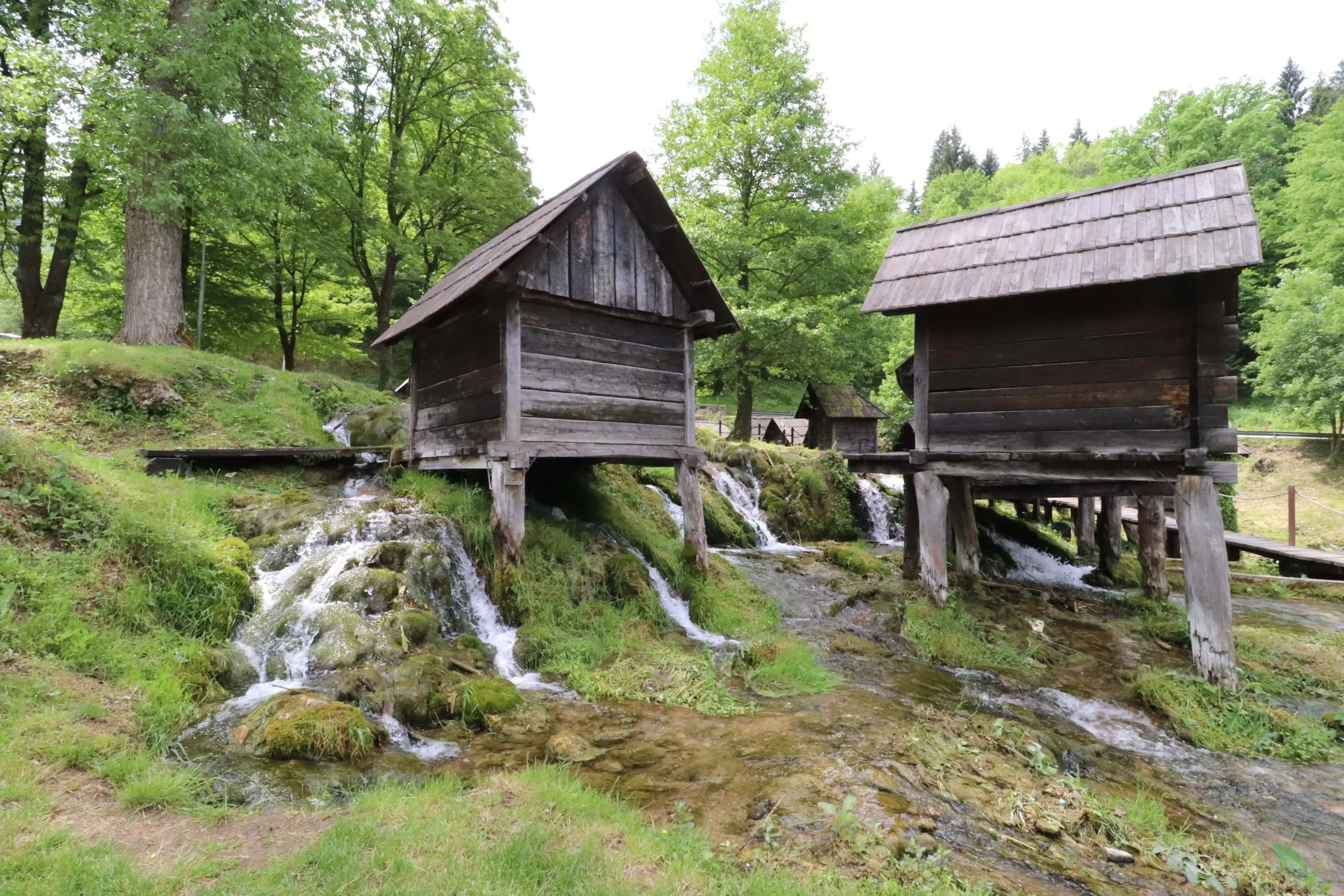 historic wooden huts that used to act as watermills have flowing water running below them - Mlinčići of Jajce, Bosnia and Herzegovina