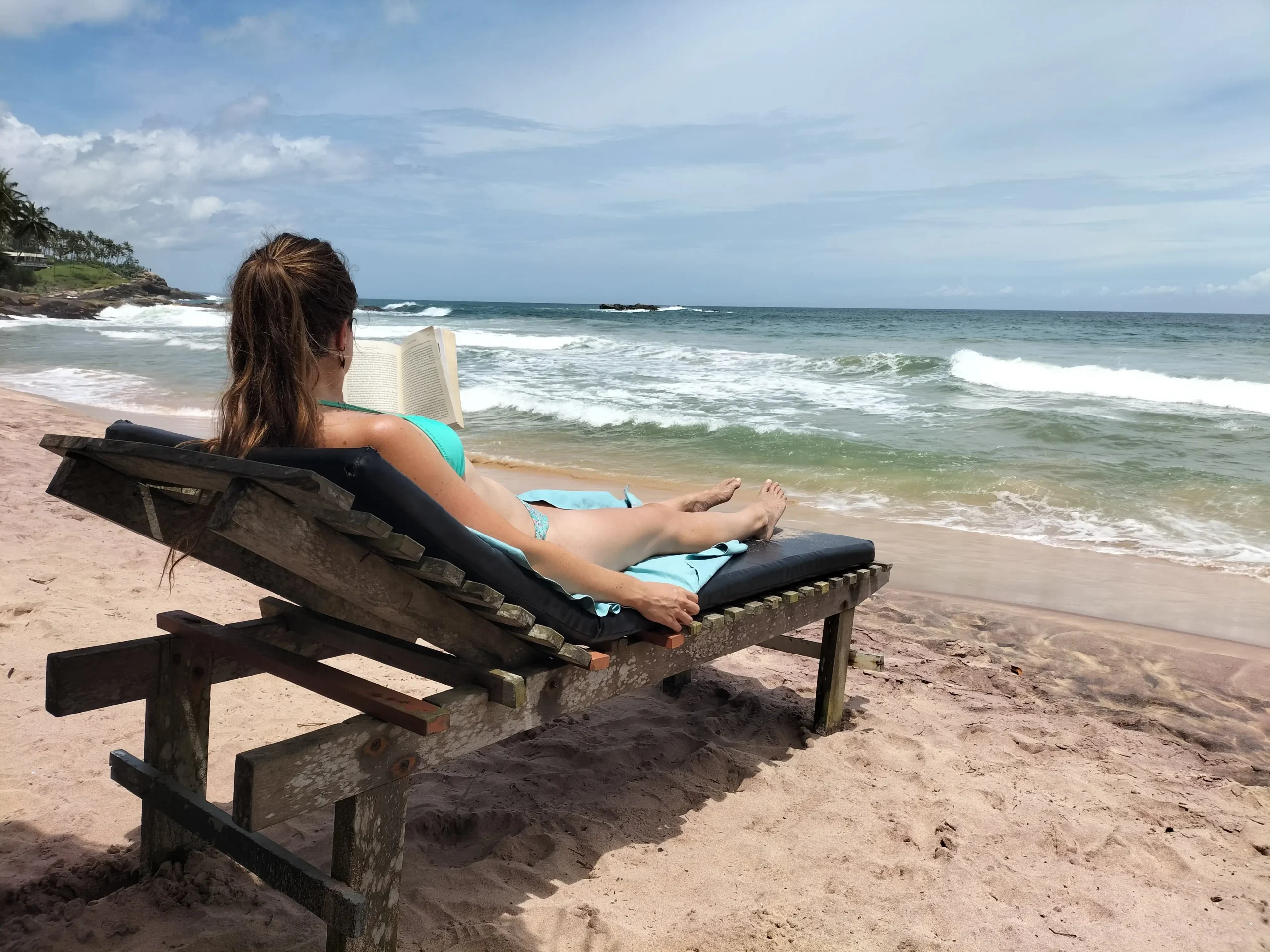 goyambokka beach a woman sunbathing on a sunlounger on Goyambokka beach, Sri Lanka