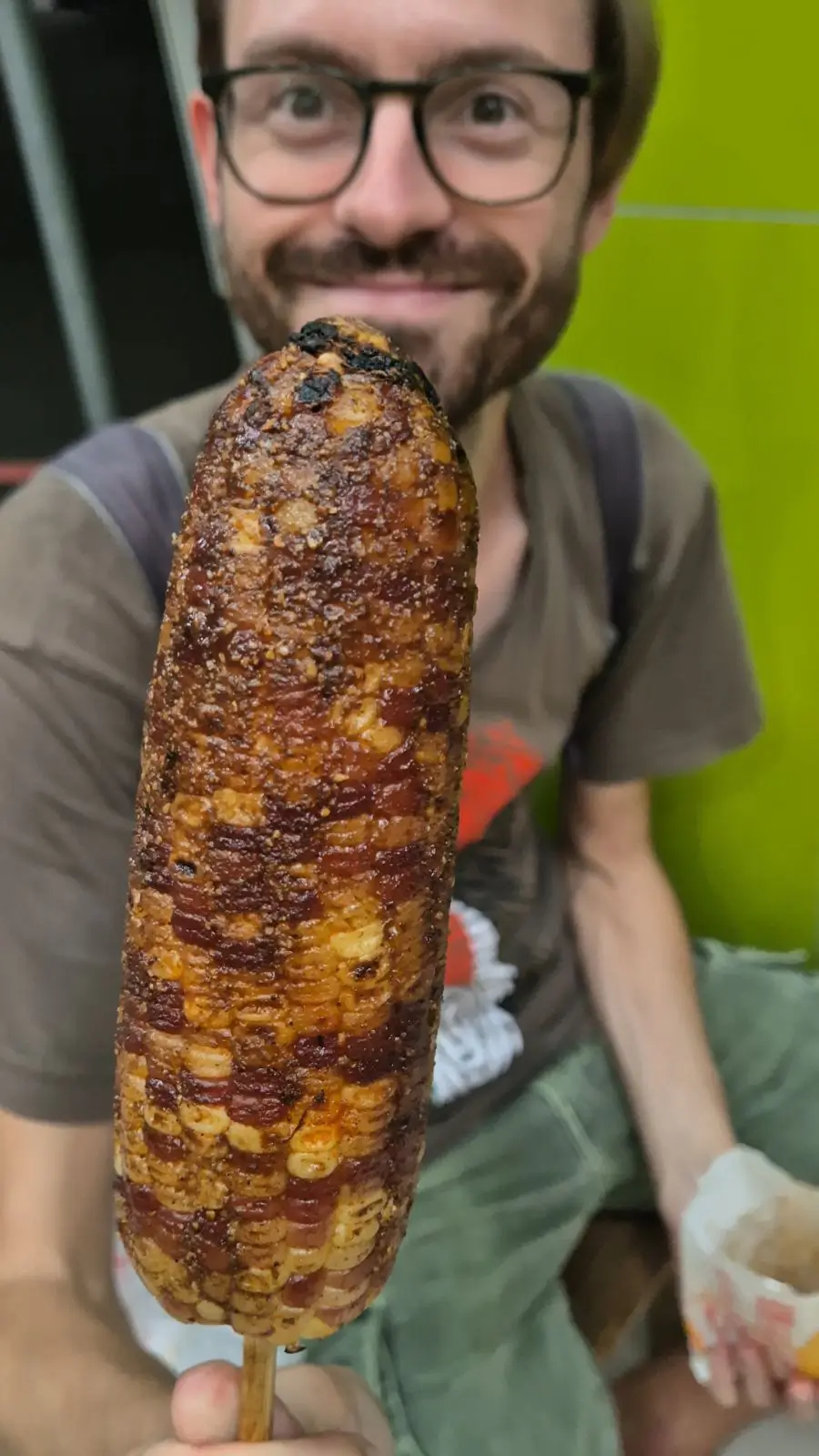 yellow and purple corn kernels on the cob covered in a sticky marinade at a Taiwanese night market