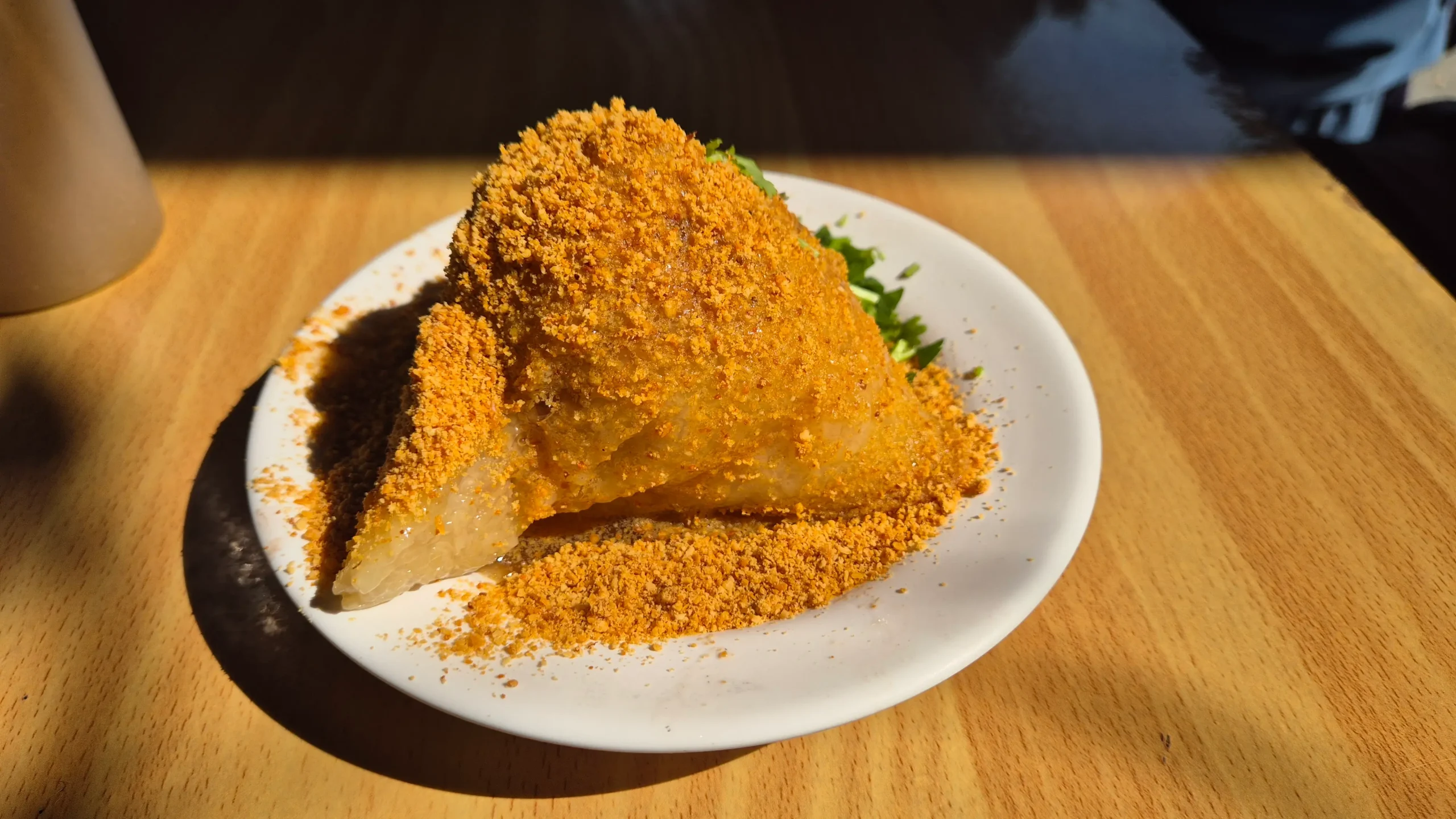 a pyramid of sticky rice covered in shaved peanuts - zongzi Taiwanese breakfast