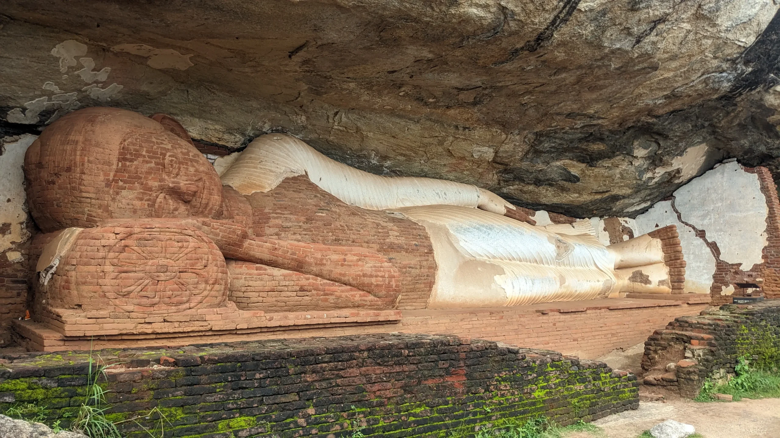 a large brick statue of a reclining Buddha en route up to Pidurangala Rock, Sigiriya, Sri Lanka