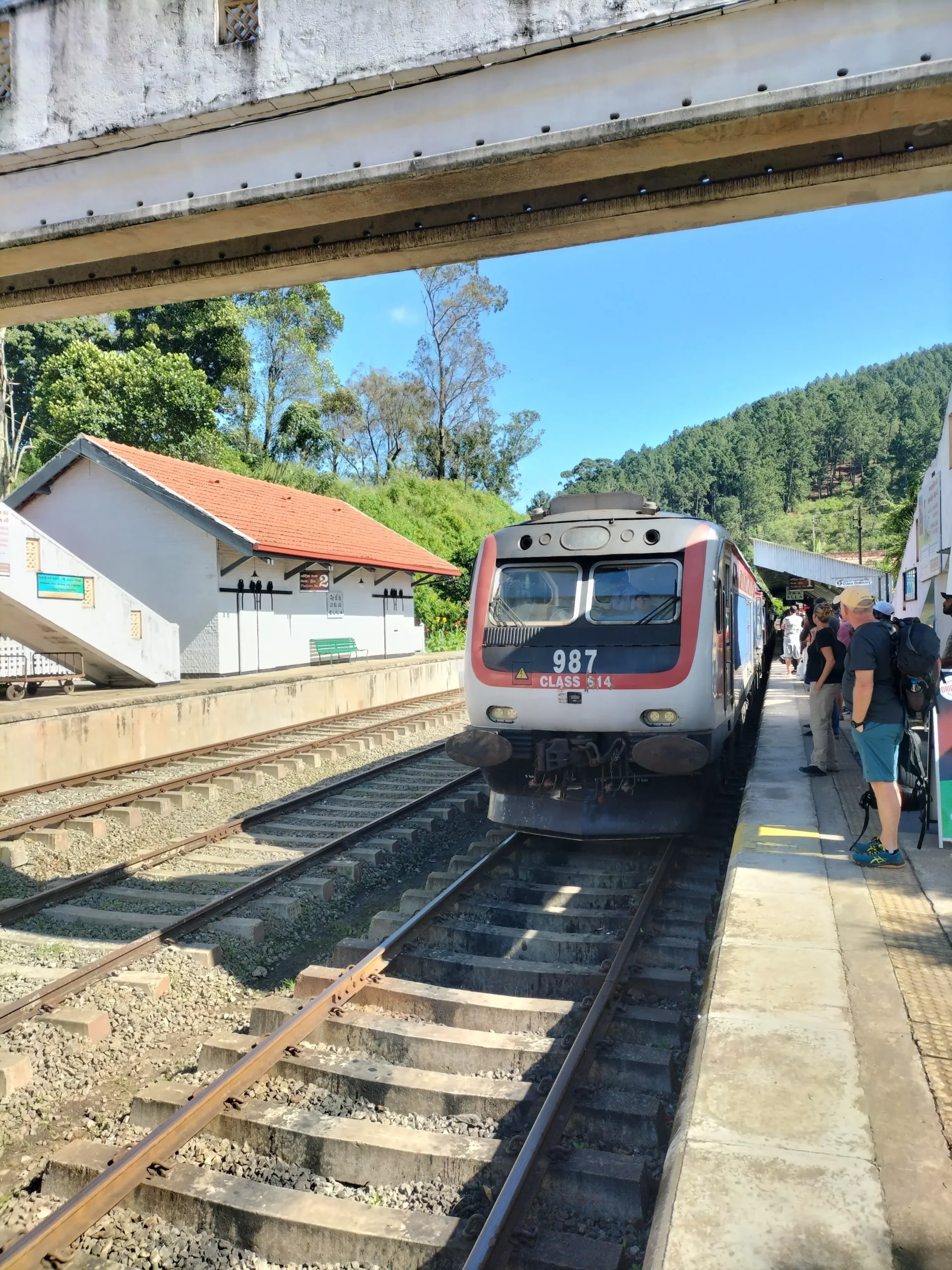 a train sits at the train station in Ella, Sri Lanka