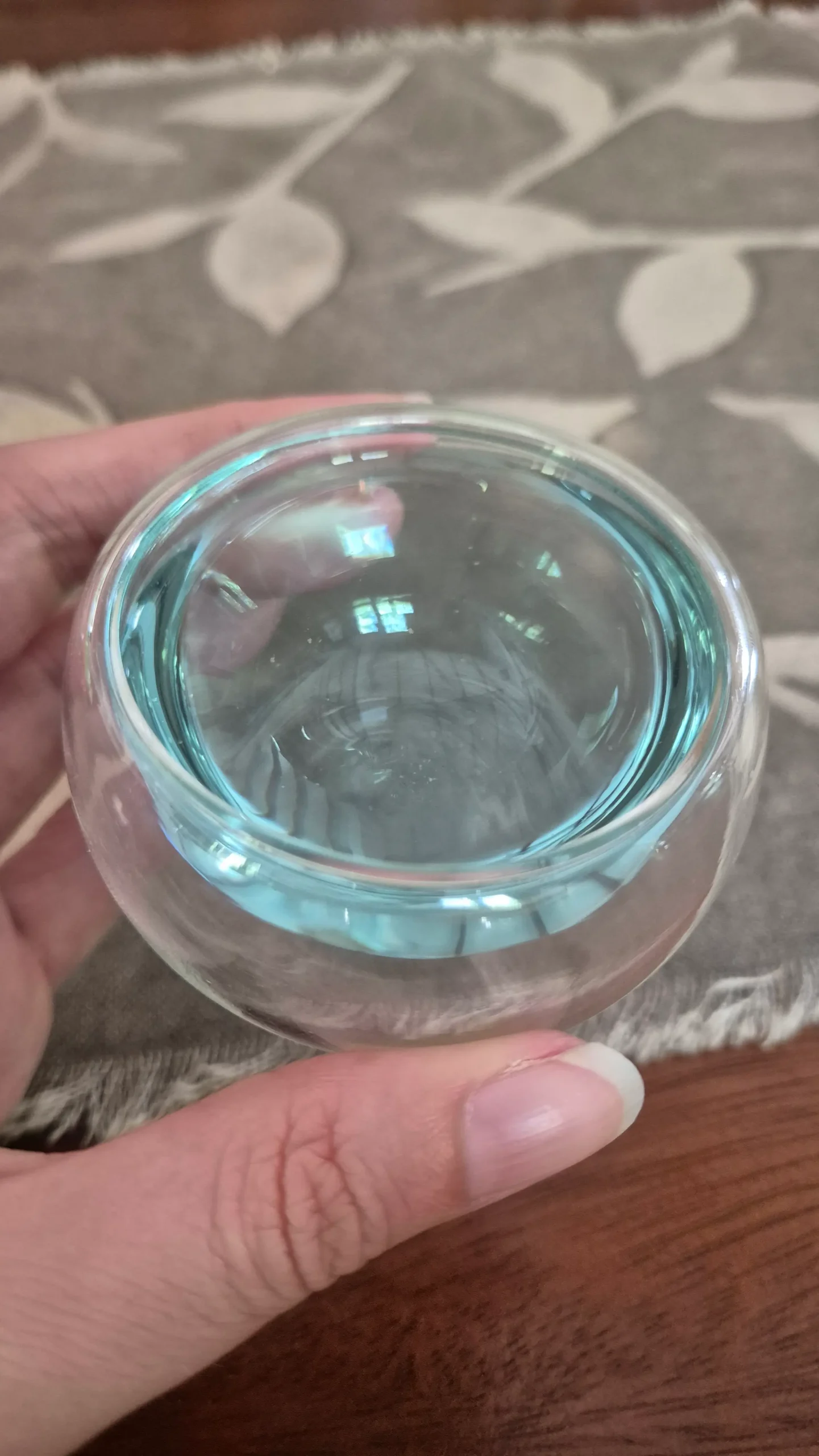 butterfly pea flower tea a small round glass has a pale blue coloured tea - butterfly pea flower tea
