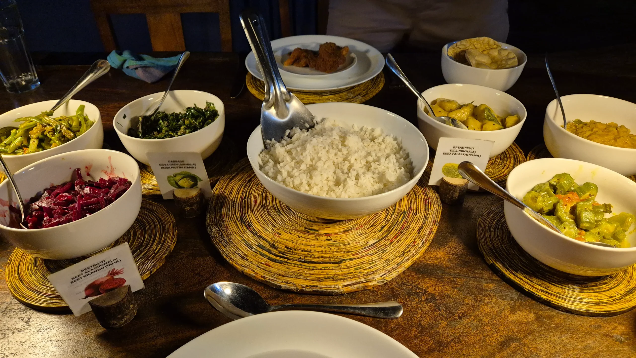rice and curry six bowls of Sri Lankan vegetarian curries plus a bowl of white rice and poppadoms