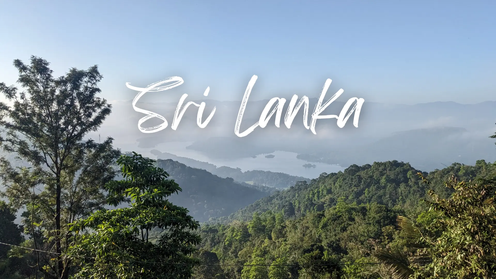 Sri Lanka Travel Guide 5 layers of mountains with a lake in the centre and a faint early morning mist. Sri Lanka travel guide