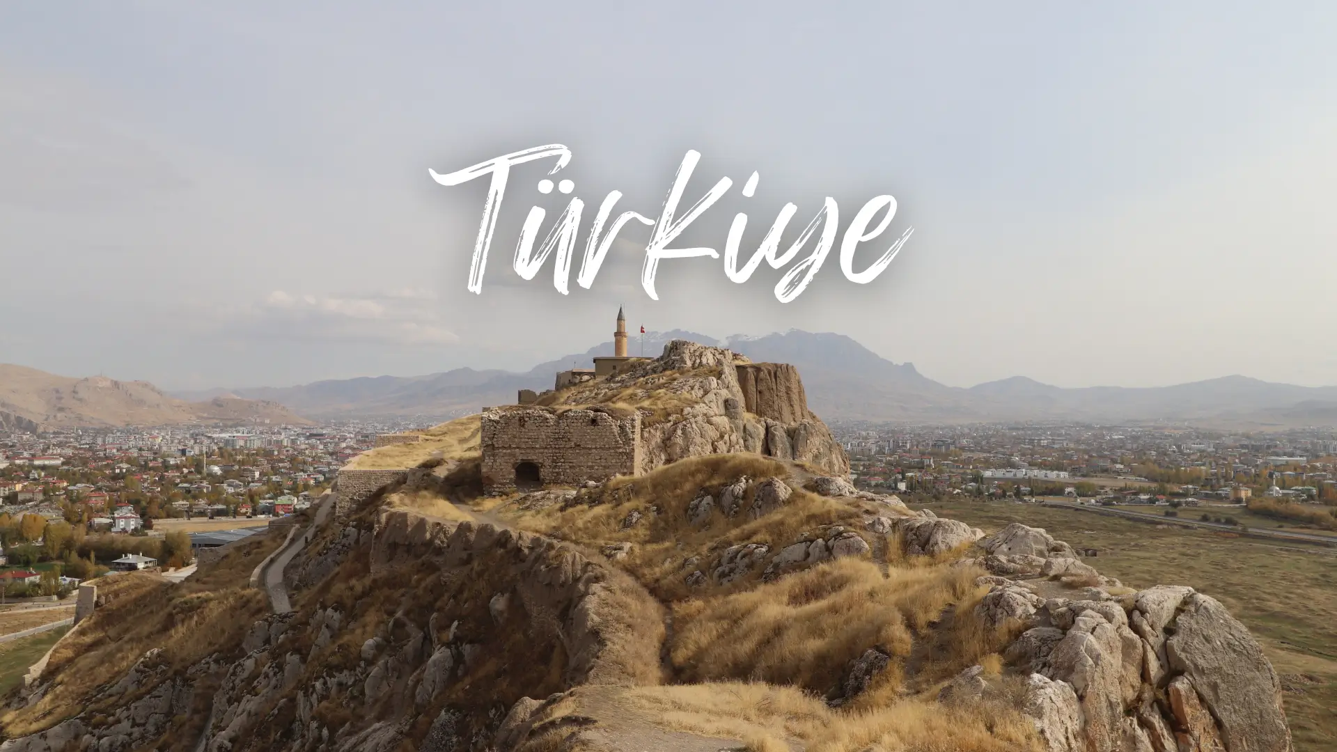 Turkey Travel Guide 6 a dirt path leads to ruins of a brick castle on a peninsula in Van. Turkey travel guide