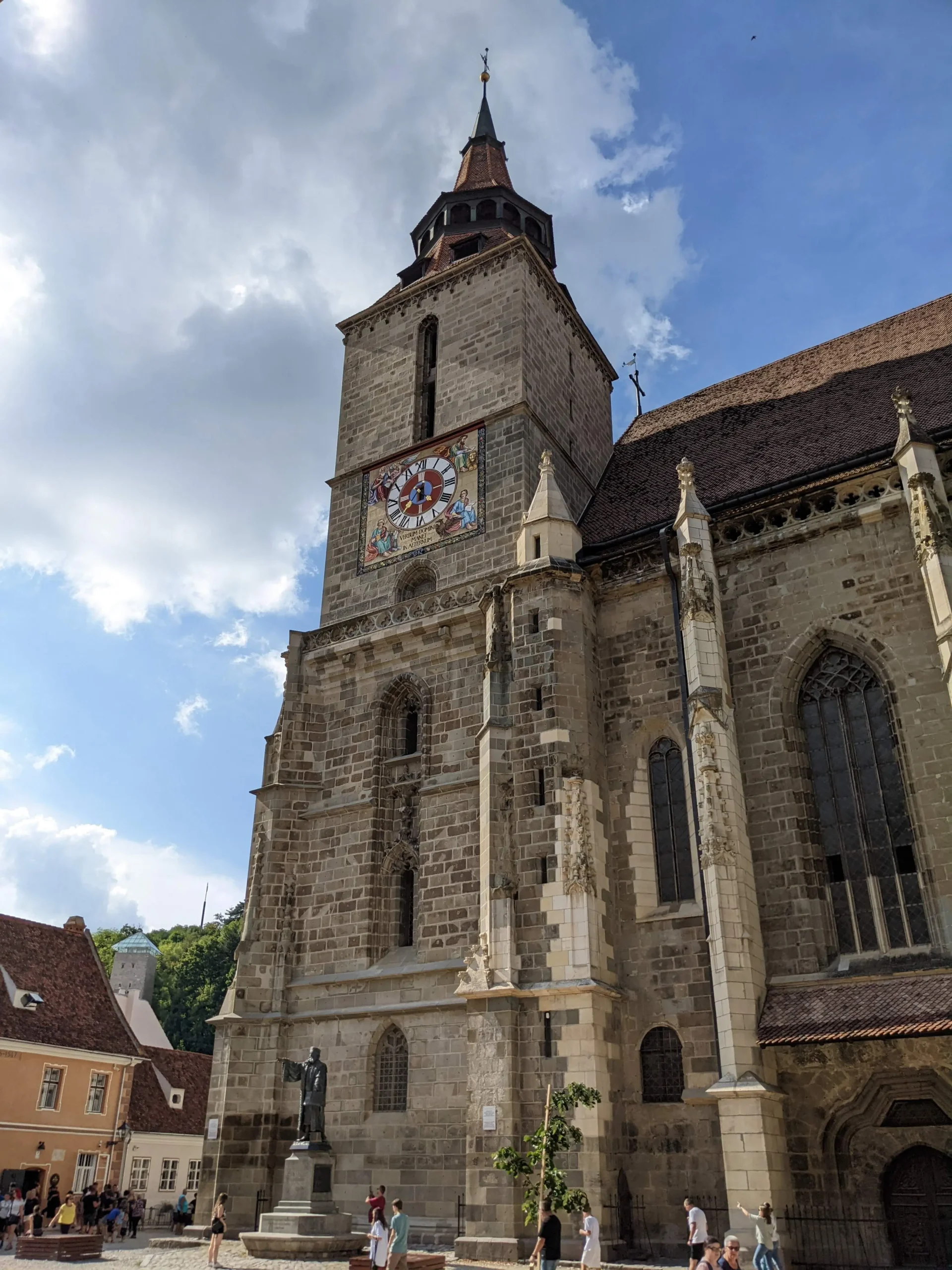 Biserica Neagră (Black Church) Brasov Brasov's Black Church (Biserica Neagră) has a statue and a tower with a tiled clock face, Romania