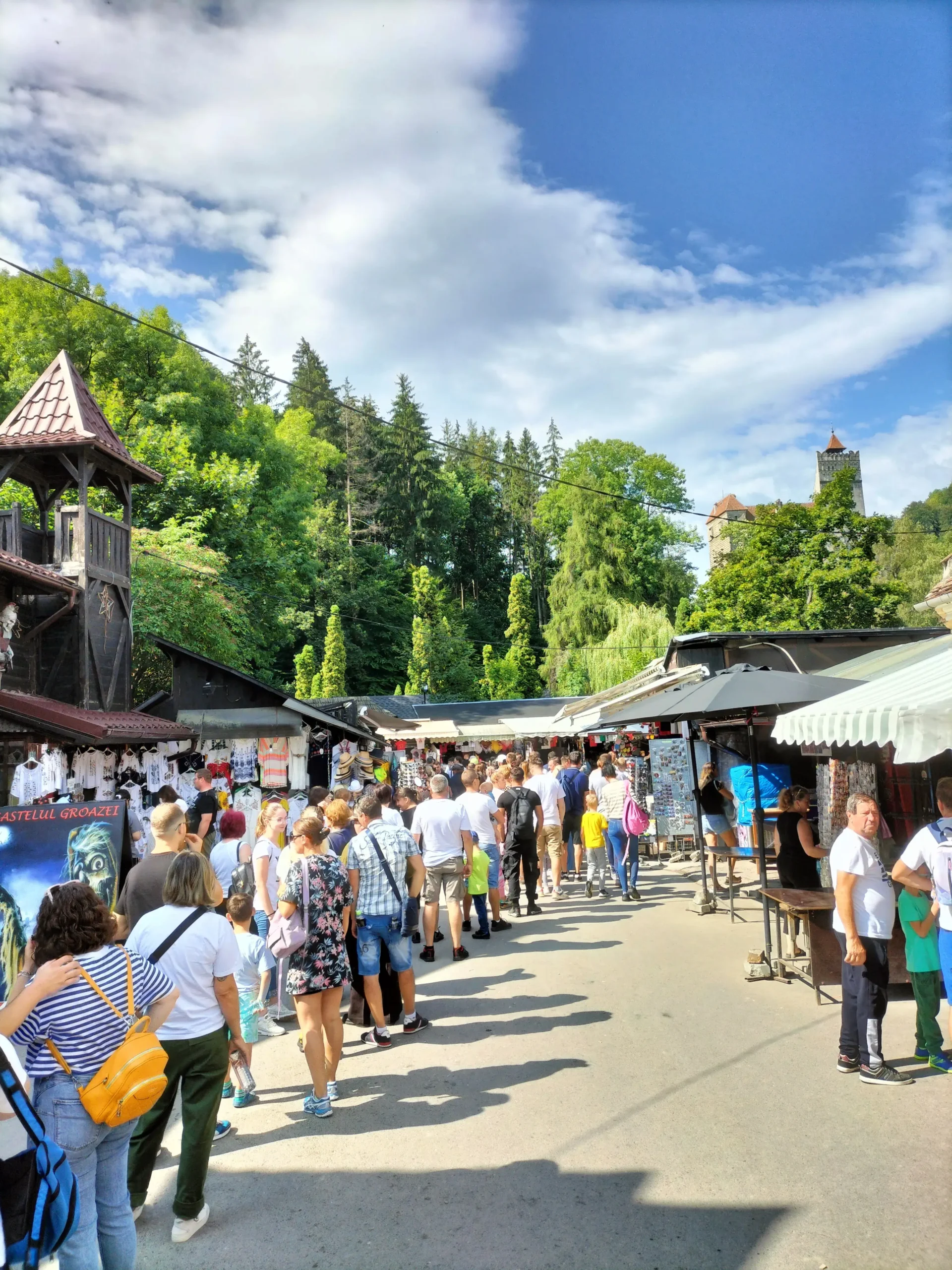 a large queue of people waiting to enter Bran Castle, Romania
