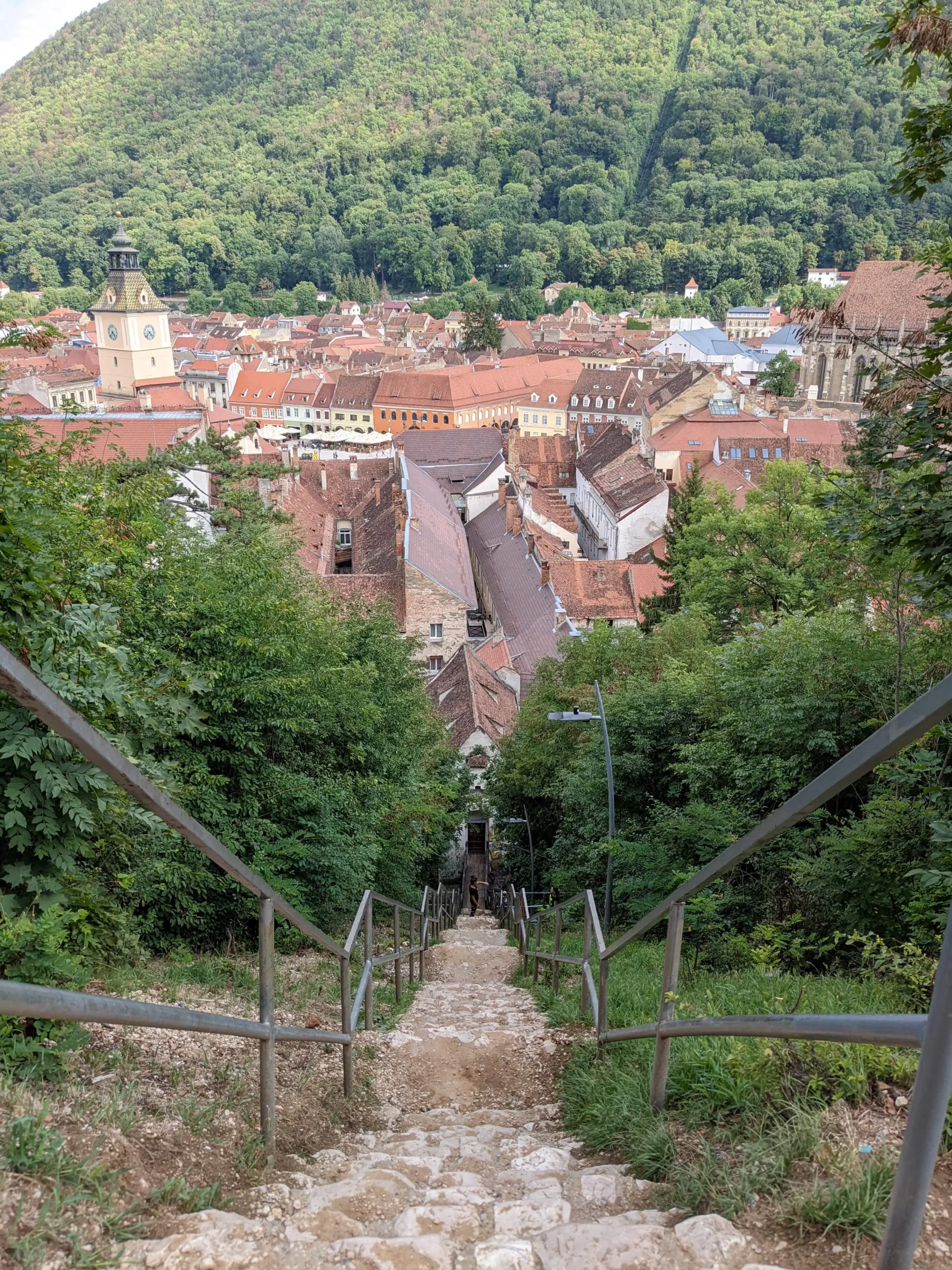 Steps down from Turnul Alb a view down a staircase with views over Brasov, Romania