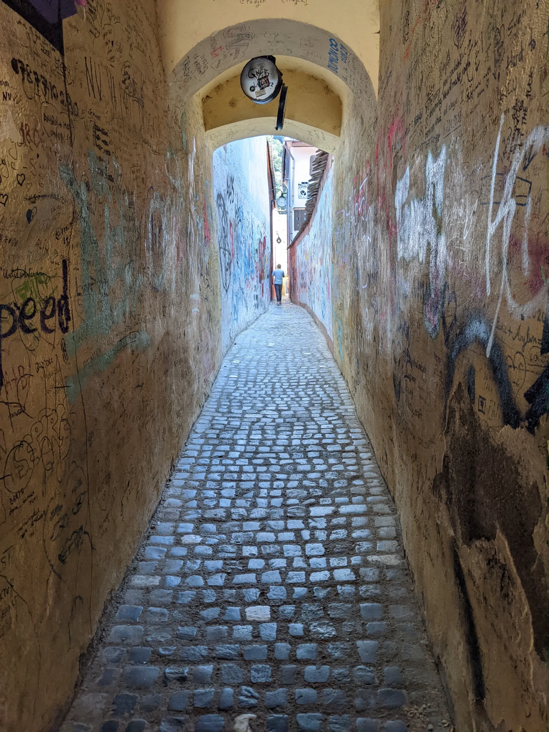 Rope Street Strada Sforii - Europe's third narrowest street has cobbles and graffiti in Brasov, Romania